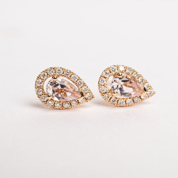 A pear is the most sold fancy shape on the market, they are hot. These Pear peach Morganite and diamonds halo studs are pretty and fit on all ears.   18kt rose gold