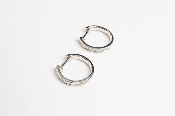 These channel set diamond hoops are on trend. The look gives a river of diamonds on each ear. Diamonds are set in 'rail tracks' which gives a more sophisticated look. The diamonds are set in the most safe way. 