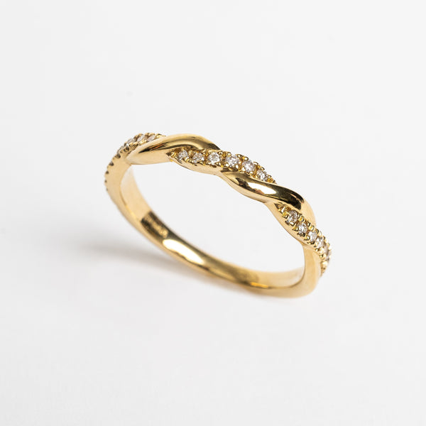 This ring is made out of two bands crossing over and over to make a full braided beautiful look. One band is plane gold and the crossing band is set with diamonds for a playful result.   18kt yellow gold  Total diamond weight for the ring approx. 0.15ct round brilliant diamonds Band width 2.8 mm