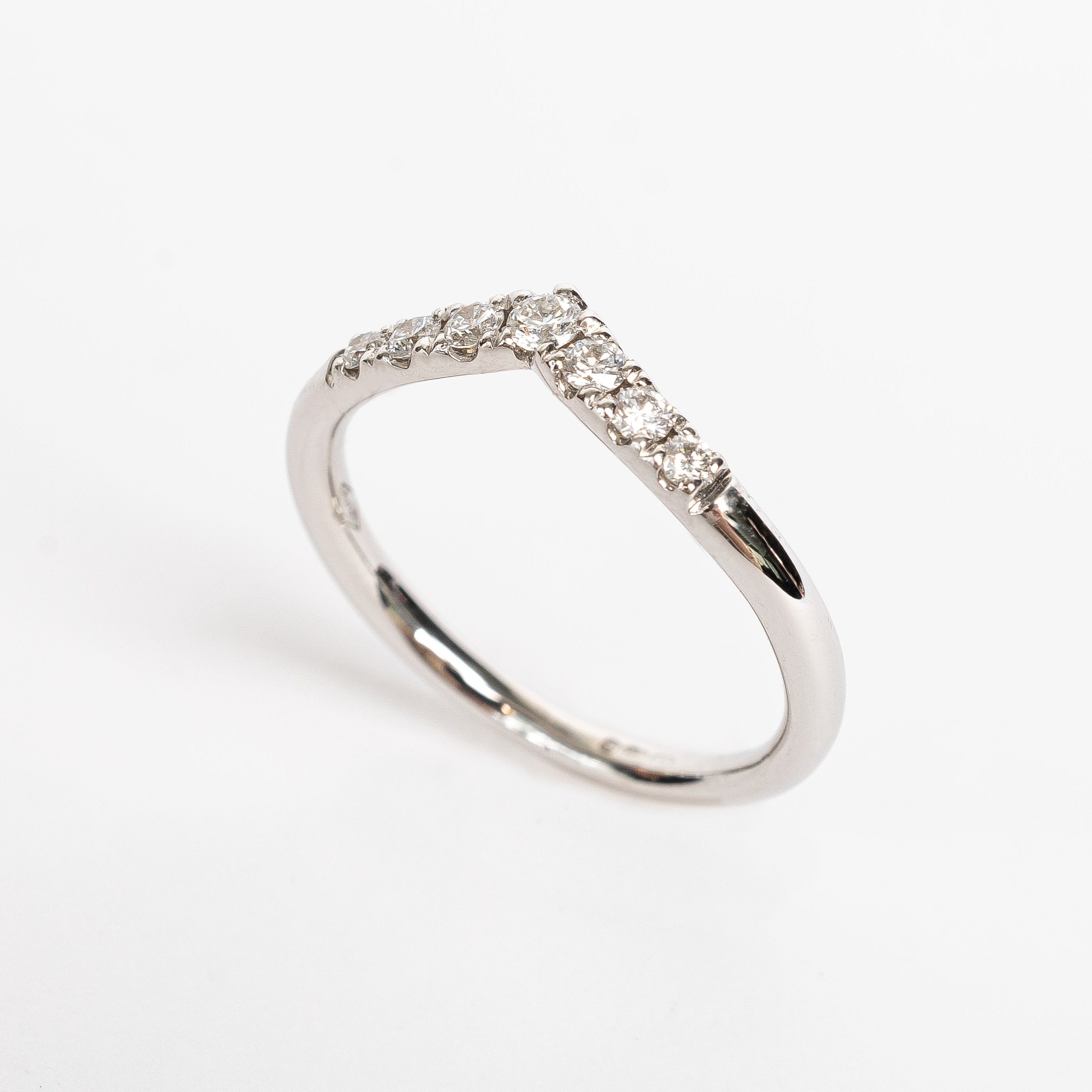 This ring has a wishbone design. The wishbone is a popular good luck symbol in the Western world. This ring is fun to stack with straight rings as it gives some funk to your ring stack.    18kt white gold