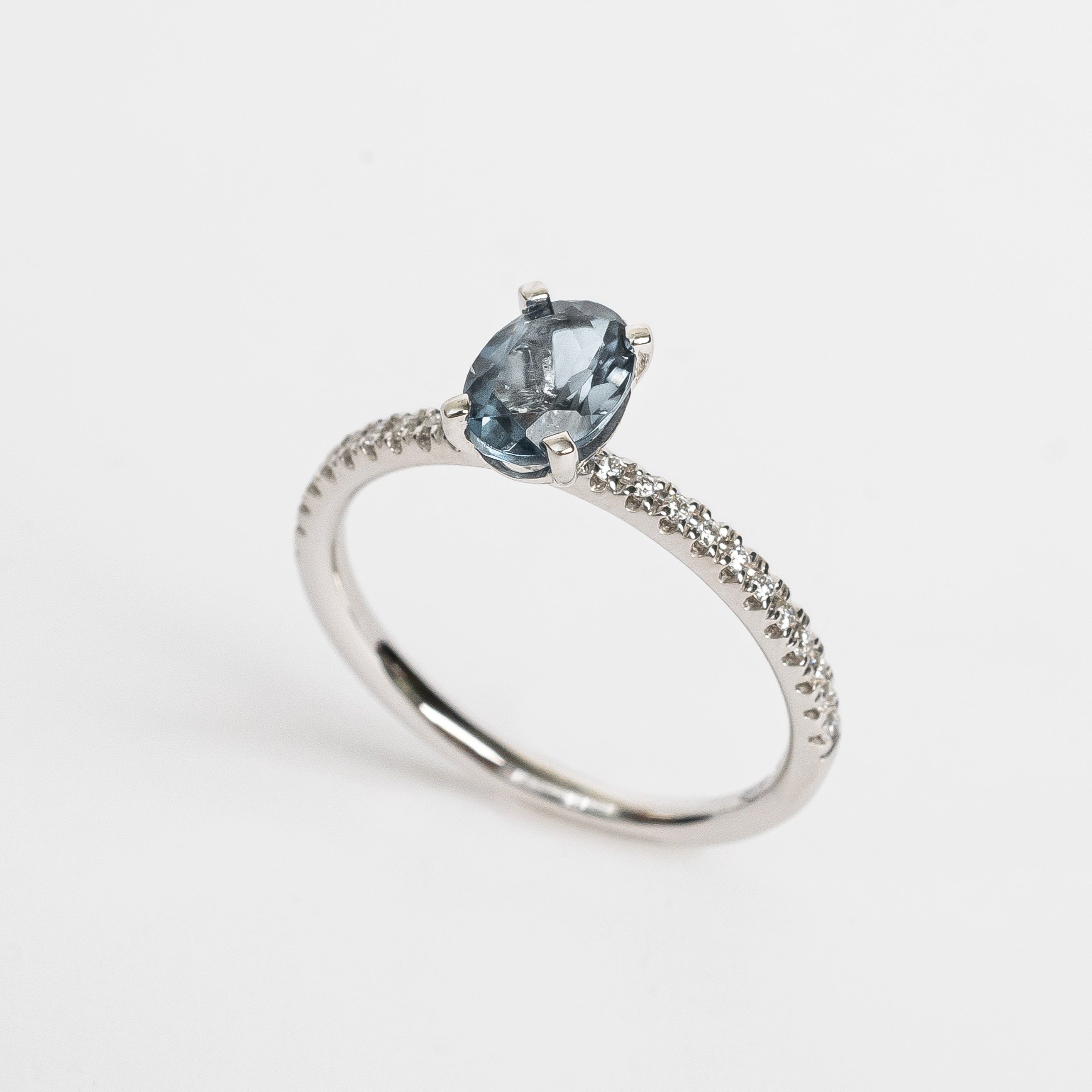 This ring is so beautiful and adds a pop of color to your look. The diamonds set on the band create extra sparkle and honours the oval cut London Topaz.