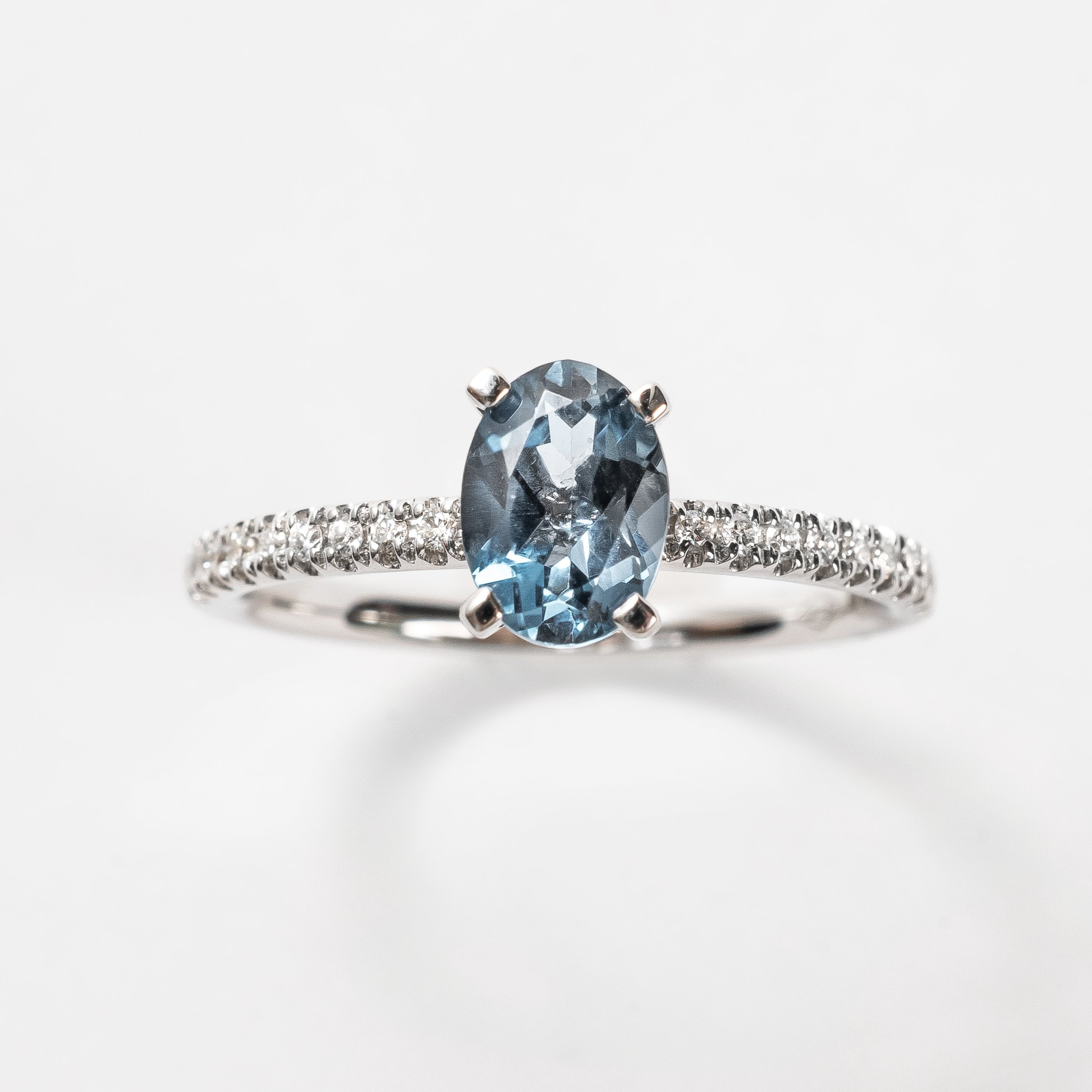 This ring is so beautiful and adds a pop of color to your look. The diamonds set on the band create extra sparkle and honours the oval cut London Topaz.