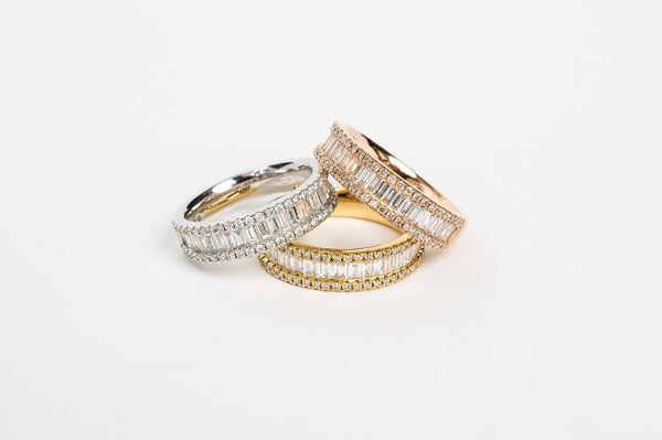 This baguette diamond ring is a showstopper! This new design is absolutely incredible. The baguette diamonds are set side by side to create sparkle from all angles. This triple row design has on both sides a row of round brilliant diamonds the close in the baguettes.   18kt yellow gold