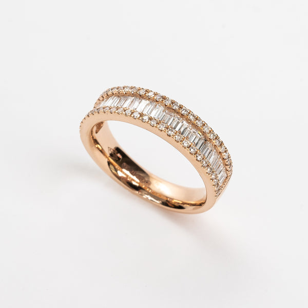 This baguette diamond ring is a showstopper! This new design is absolutely incredible. The baguette diamonds are set side by side to create sparkle from all angles. This triple row design has on both sides a row of round brilliant diamonds the close in the baguettes.   18kt rose gold