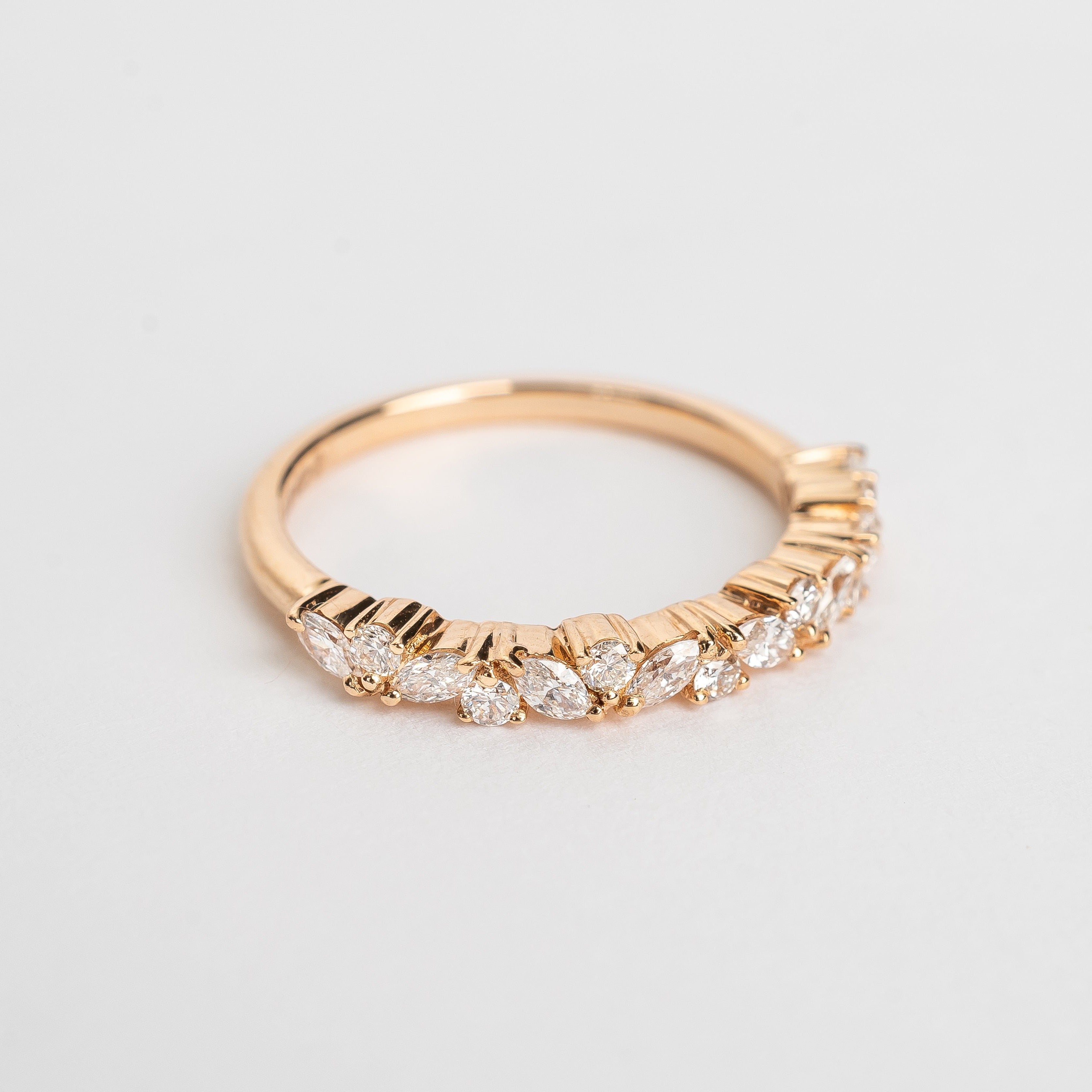 This band is set with different cut diamonds. It's a playful result between marquise cut and round cut diamonds. This style gives any look some extra sparkle.  18kt rose gold