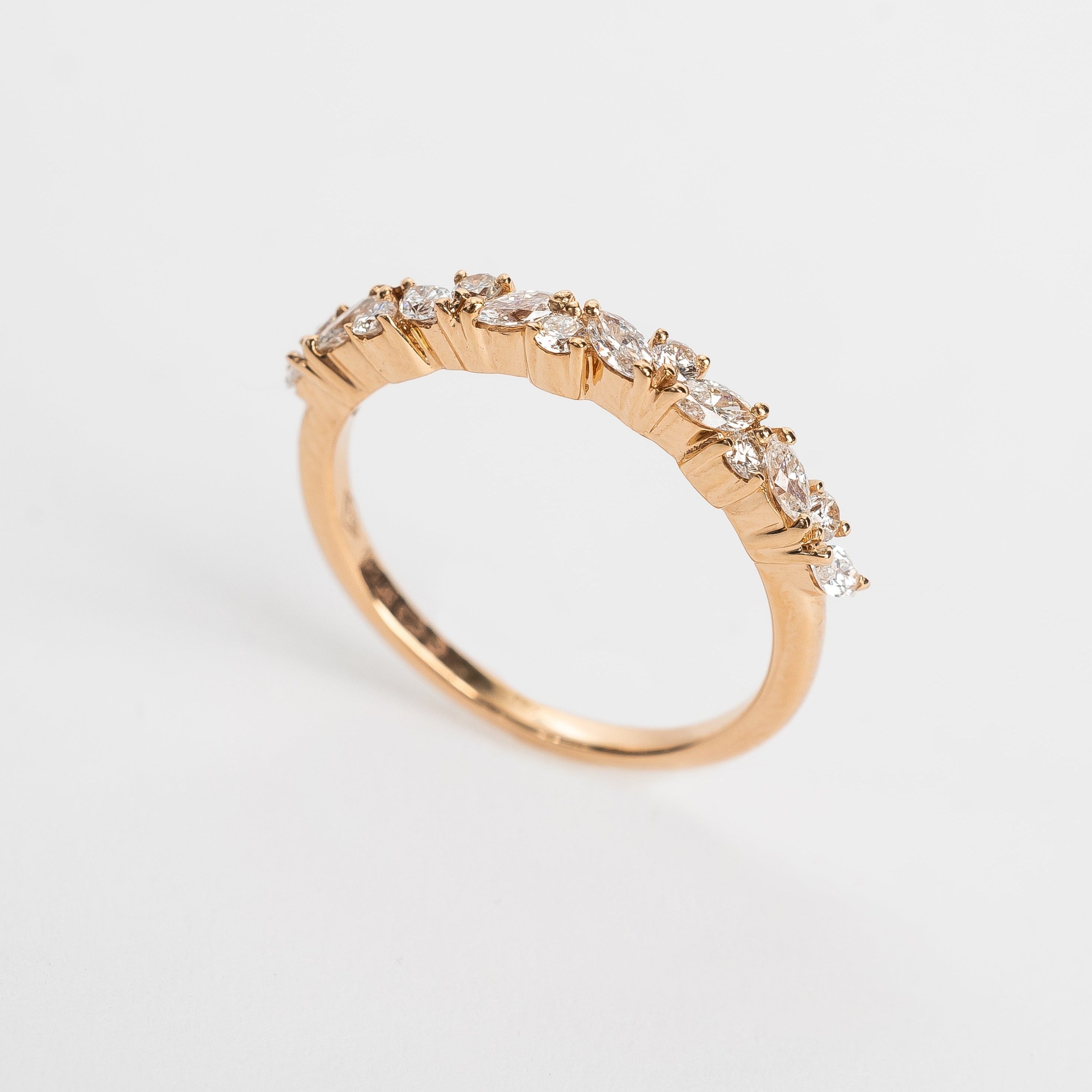 This band is set with different cut diamonds. It's a playful result between marquise cut and round cut diamonds. This style gives any look some extra sparkle.  18kt rose gold