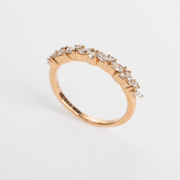 This band is set with different cut diamonds. It's a playful result between marquise cut and round cut diamonds. This style gives any look some extra sparkle.  18kt rose gold