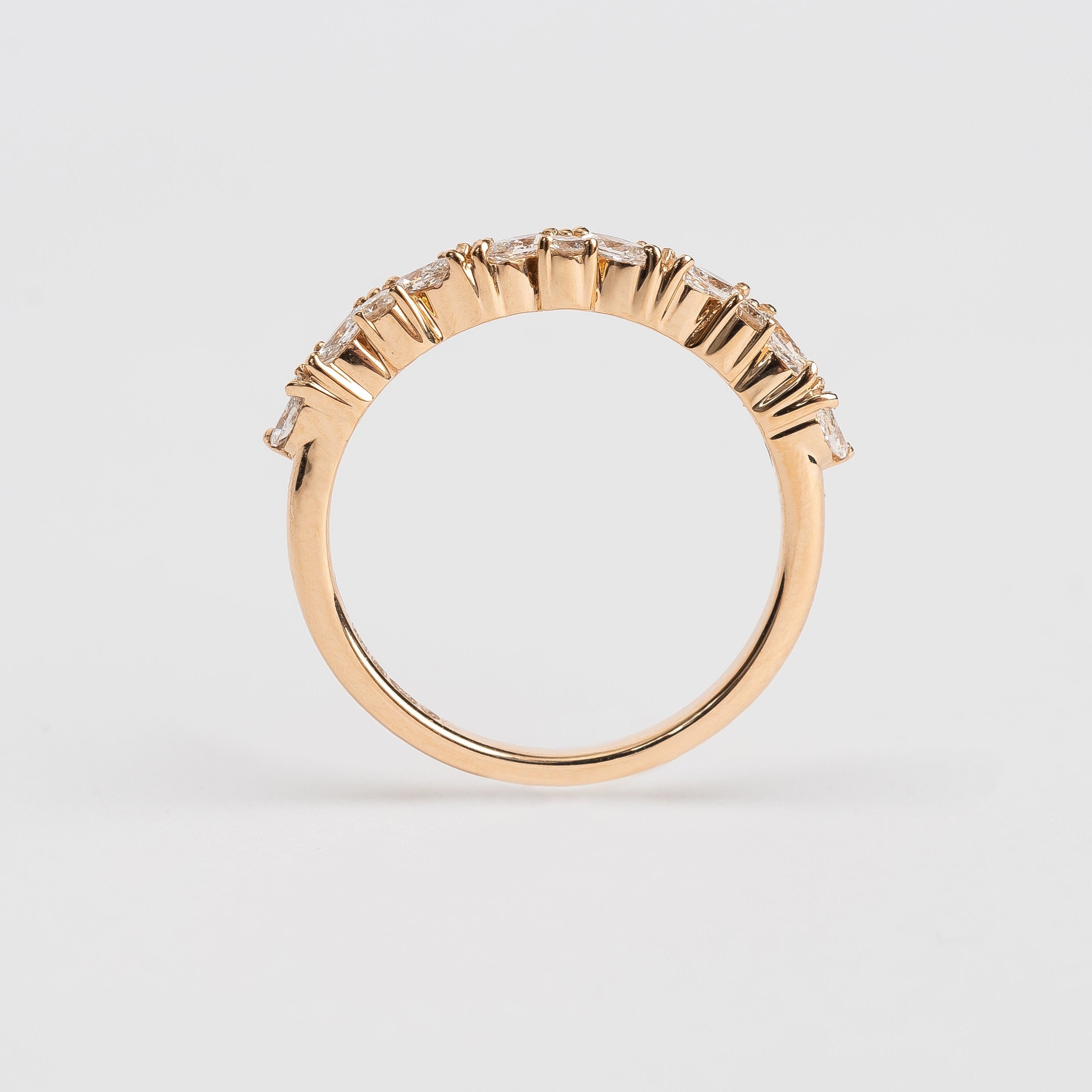 This band is set with different cut diamonds. It's a playful result between marquise cut and round cut diamonds. This style gives any look some extra sparkle.  18kt rose gold