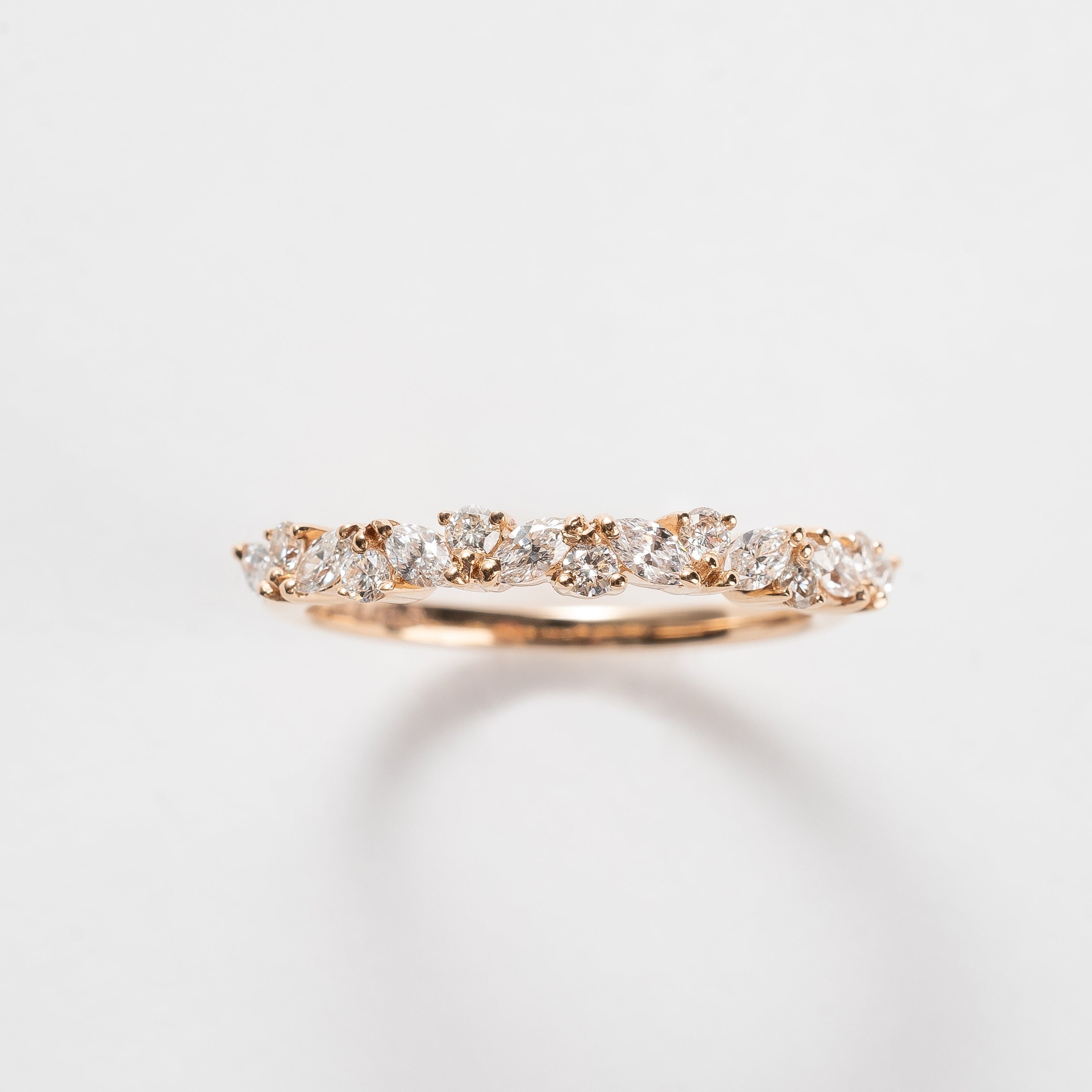 This band is set with different cut diamonds. It's a playful result between marquise cut and round cut diamonds. This style gives any look some extra sparkle.  18kt rose gold