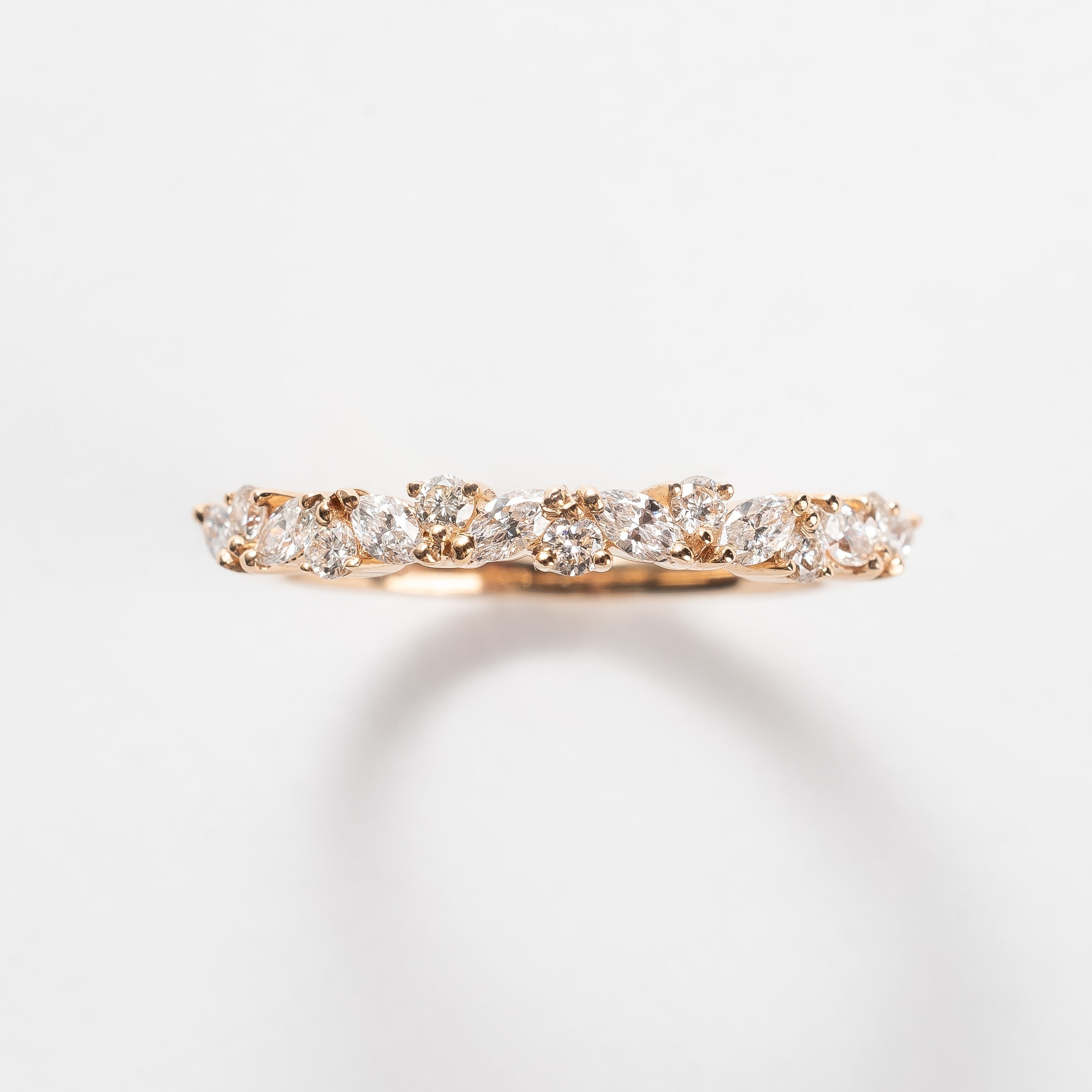 This band is set with different cut diamonds. It's a playful result between marquise cut and round cut diamonds. This style gives any look some extra sparkle.  18kt rose gold