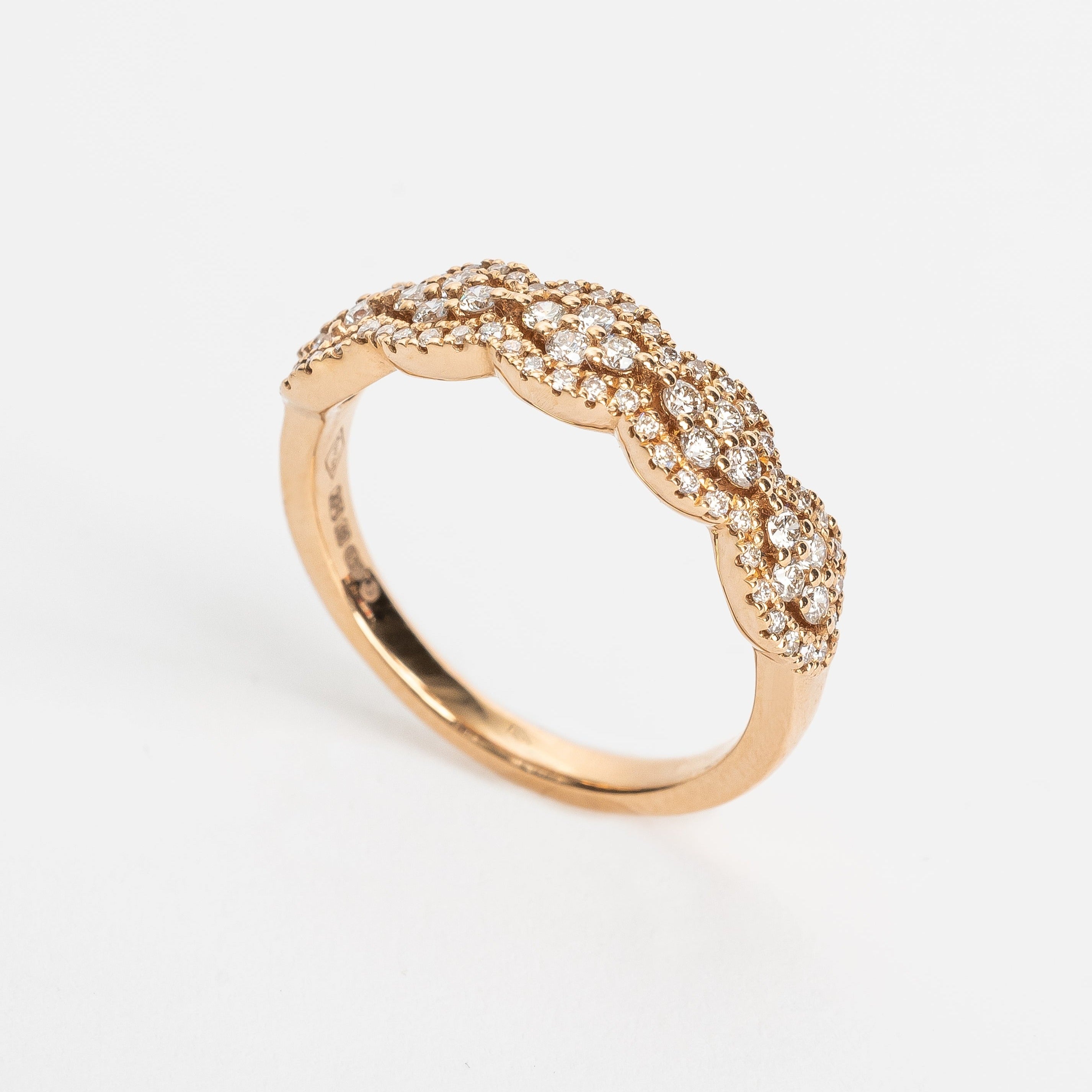 This waved fancy ring has a fancy romantic look. The placement of the stones can remind you from beautiful lace. The stones wave each time around 4 round brilliant stones set in a rhombus in the middle.   18kt rose gold