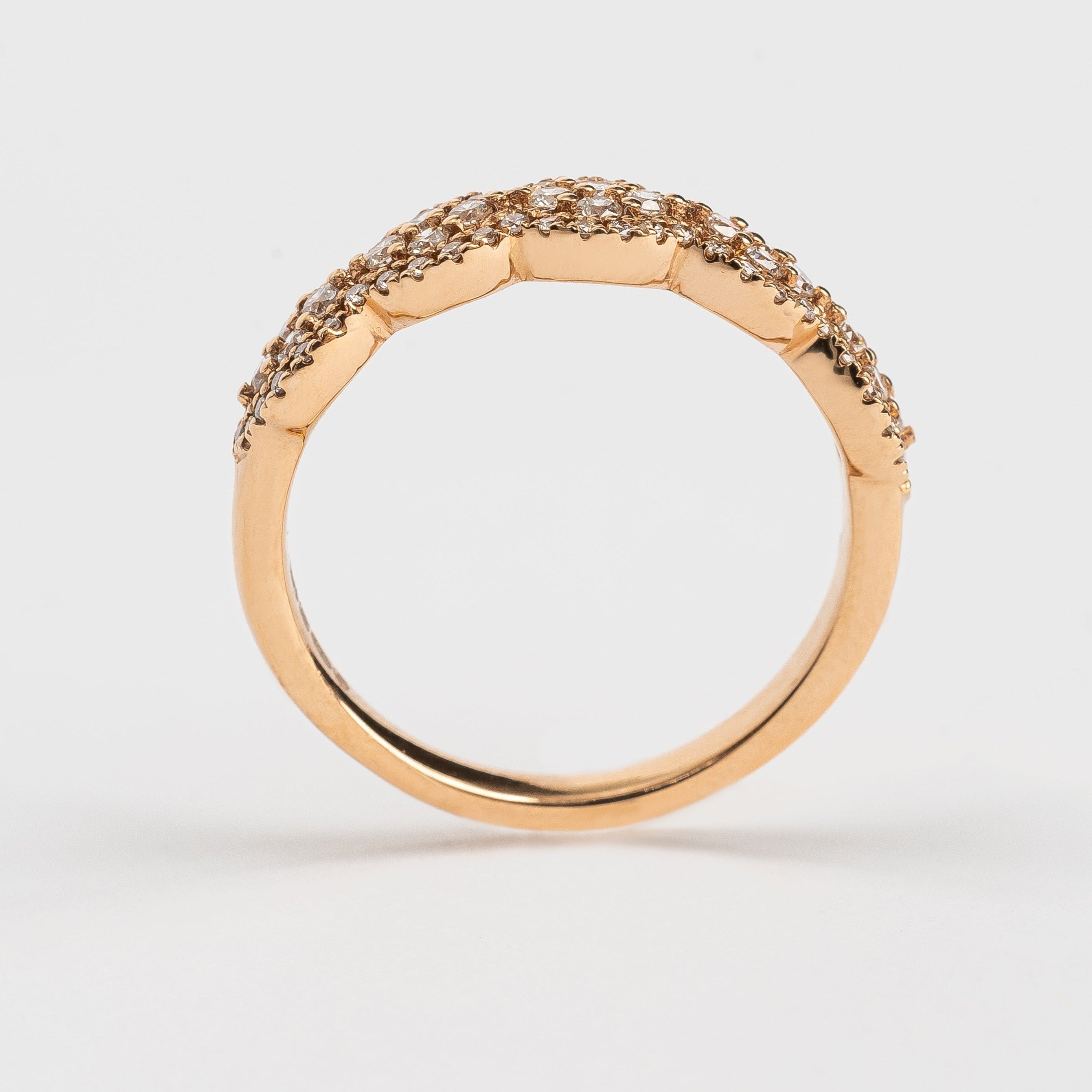 This waved fancy ring has a fancy romantic look. The placement of the stones can remind you from beautiful lace. The stones wave each time around 4 round brilliant stones set in a rhombus in the middle.   18kt rose gold