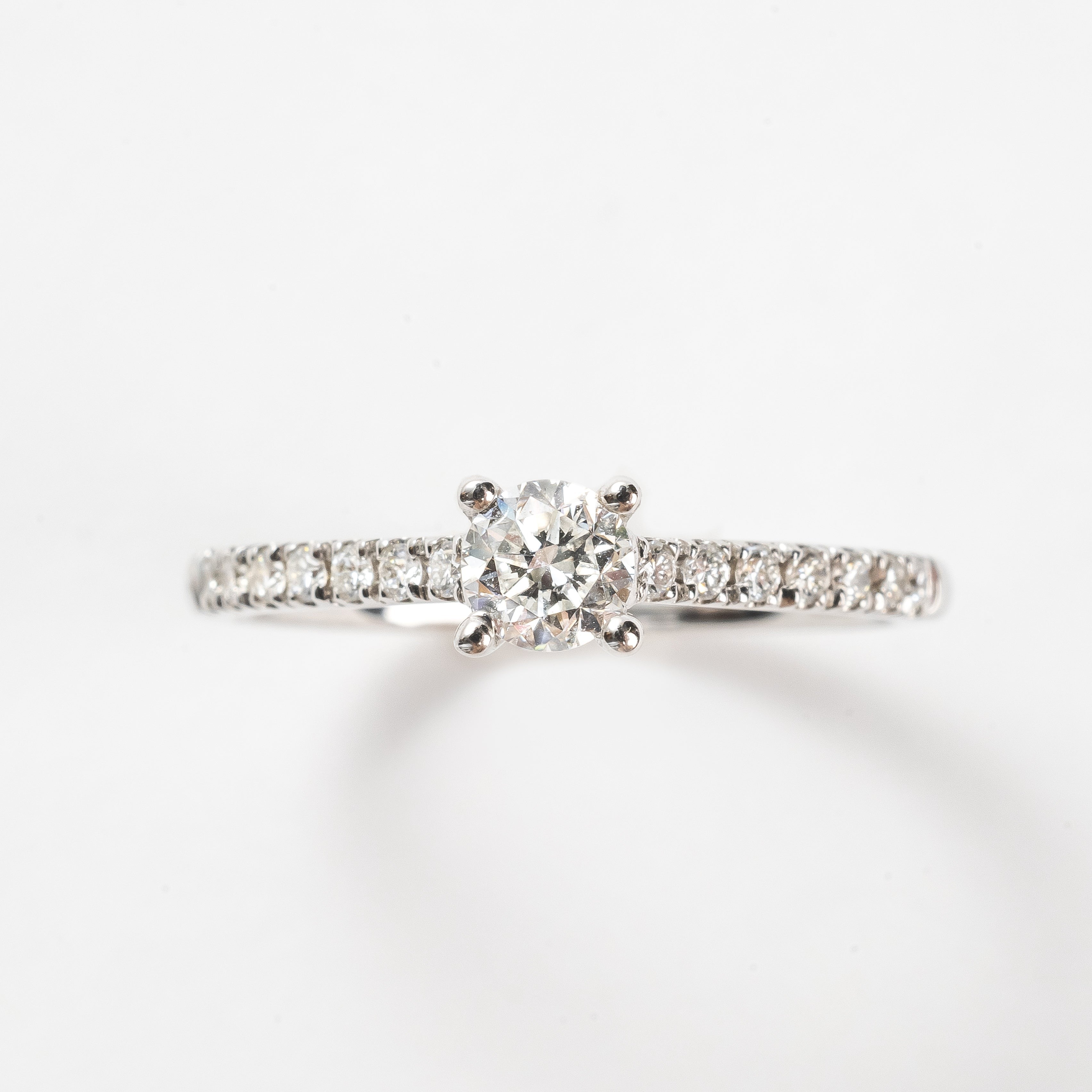 This white gold diamond ring is set with diamonds over half the band. This ring is a classic and precious design. We also have this ring available without the diamonds on the band if you are look for something even more timeless.