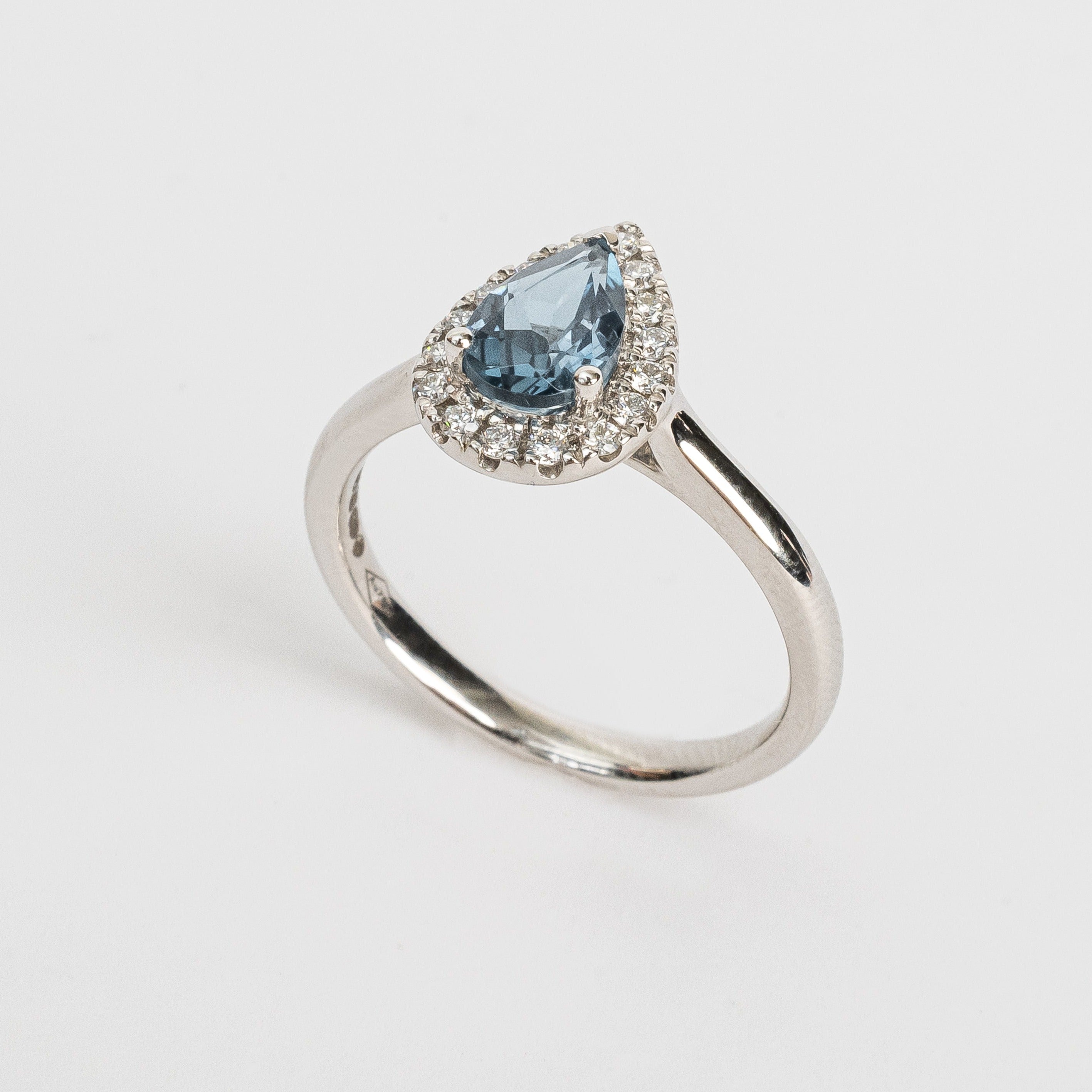 This white golden ring with a pear cut London blue Topaz gemstone in the center surrounded by a pear shaped halo. This ring is stunning!  It has a classic vibe because but it's in so many ways a modern style. Did you know a pear cut is the most wanted fancy shape.