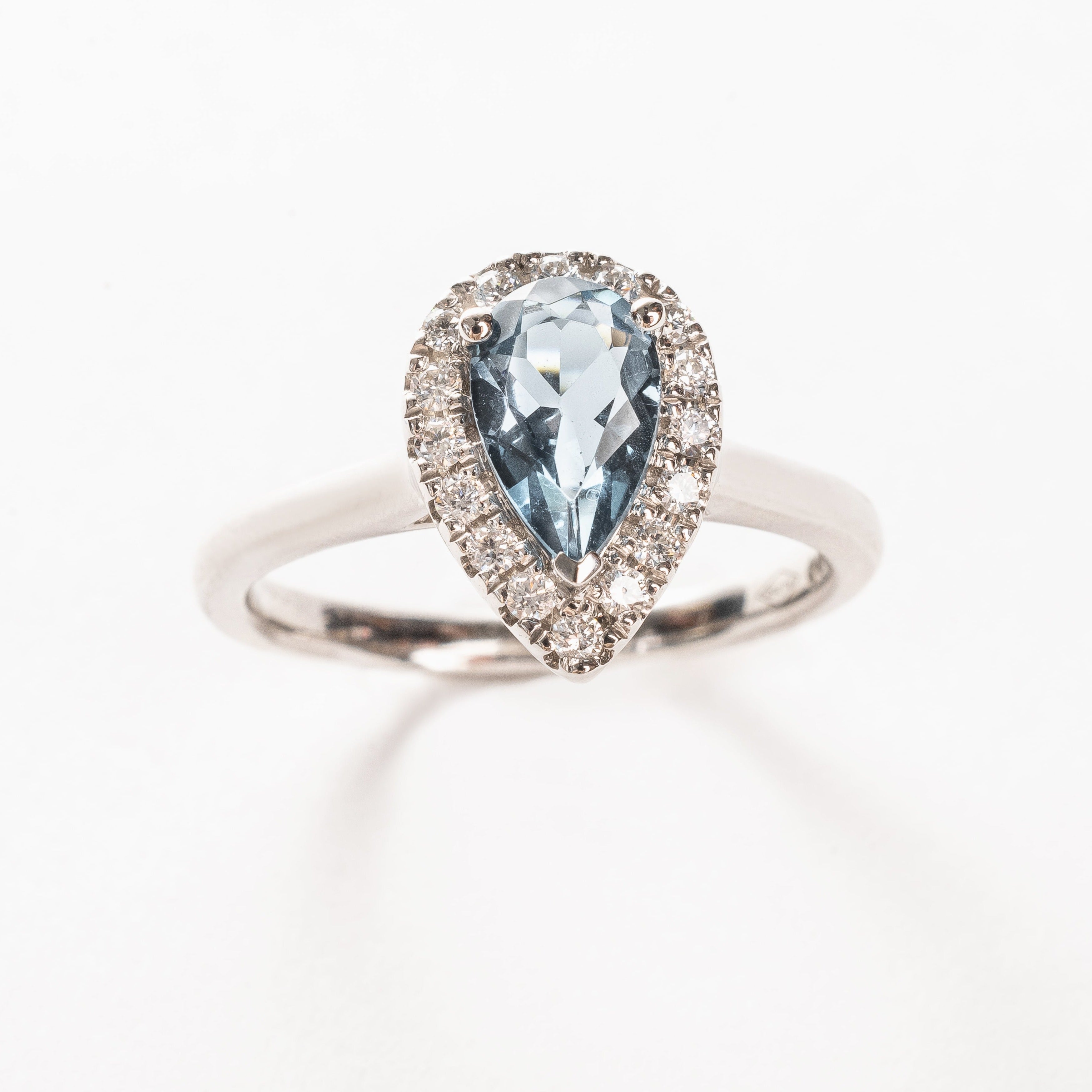 This white golden ring with a pear cut London blue Topaz gemstone in the center surrounded by a pear shaped halo. This ring is stunning!  It has a classic vibe because but it's in so many ways a modern style. Did you know a pear cut is the most wanted fancy shape.