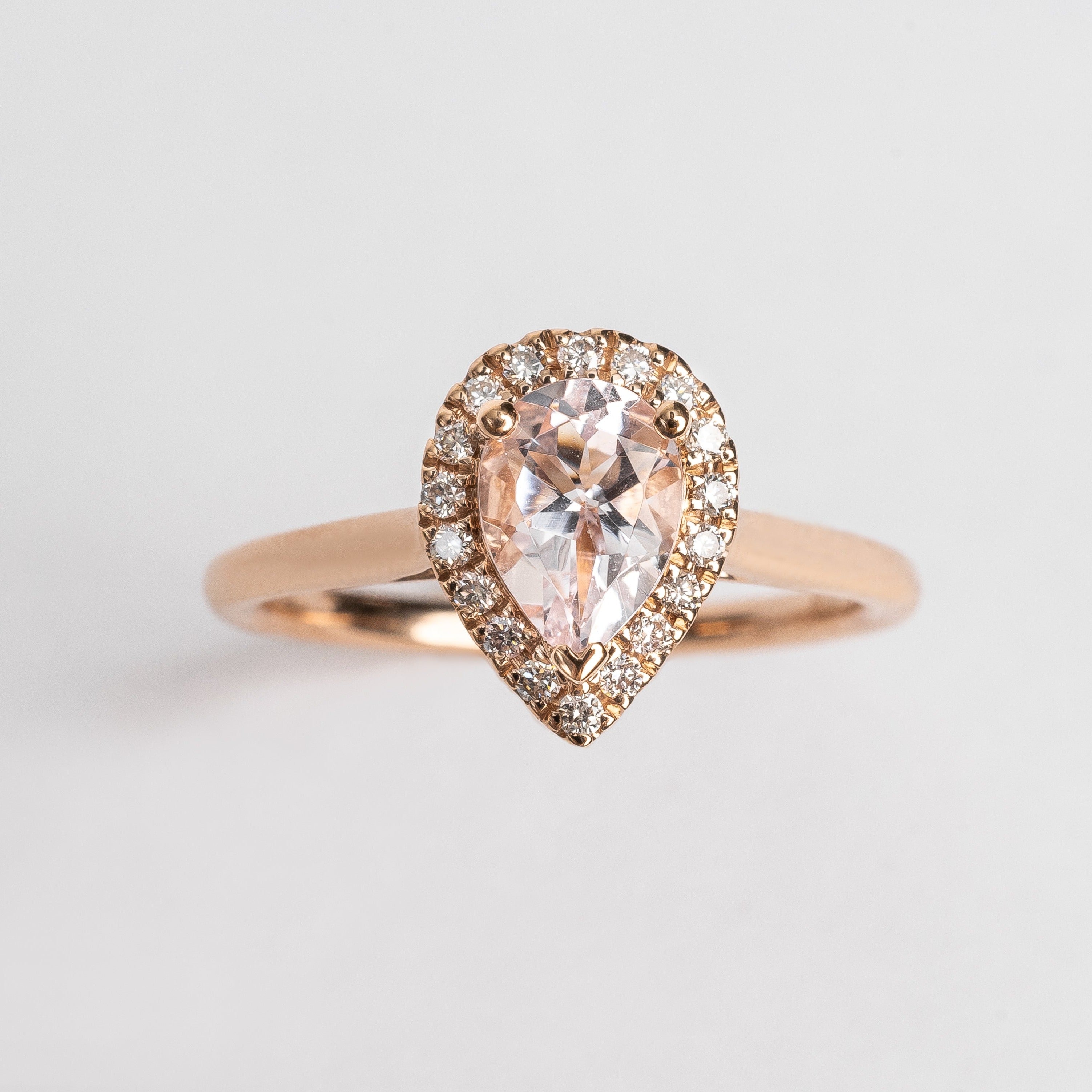 This rose golden ring with a pear cut pink Morganite is surrounded by a beautiful pear shaped diamond halo.   This ring looks so soft and feminine.   Pear cut is the most wanted fancy shape.