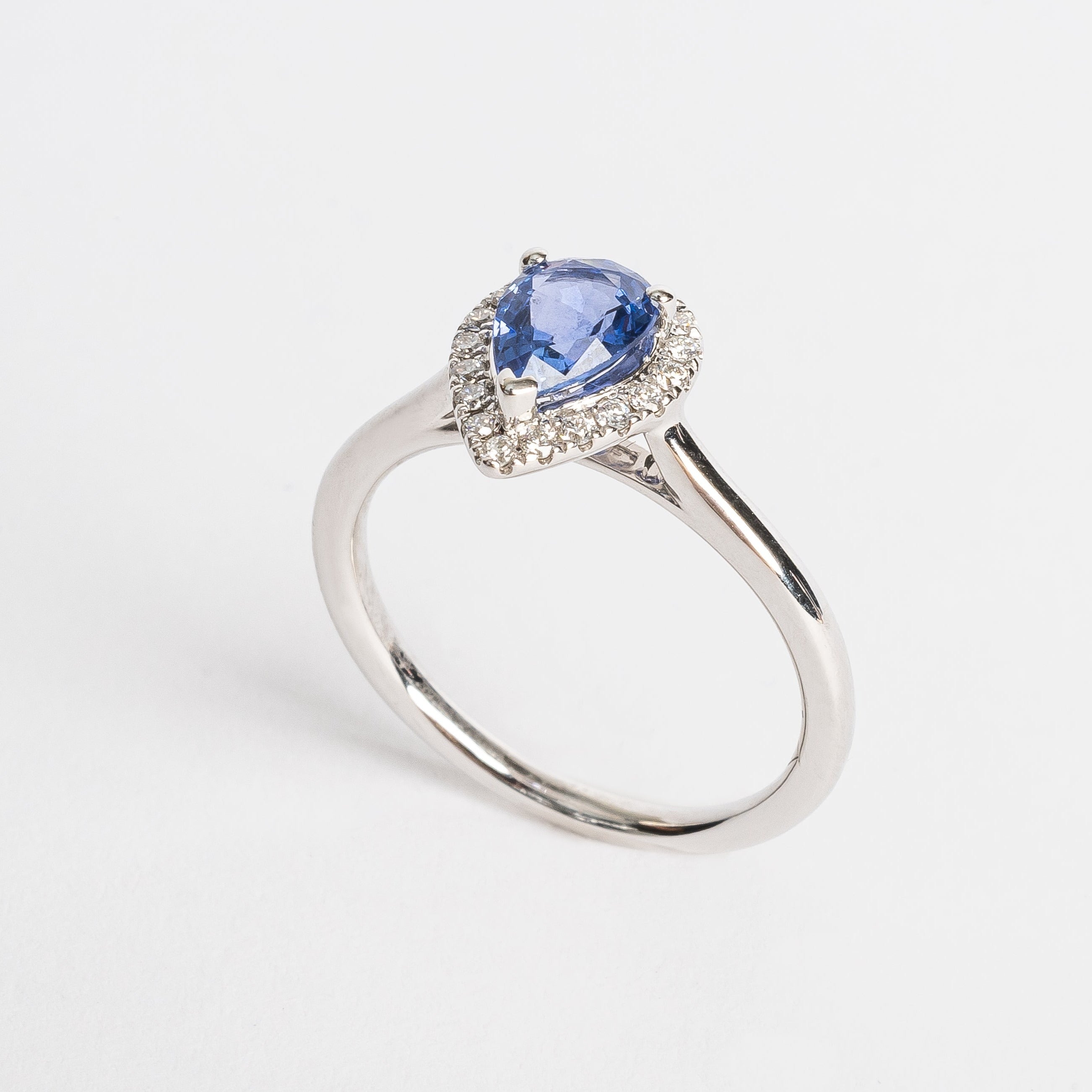 This white golden ring with a pear cut blue Sapphire is timeless. The blue Sapphire is surrounded by a halo of diamonds. The blue of the Sapphire and the white metal color match perfectly together.   The blue Sapphire gives your look a nice pop of color.   The pear cut is the most wanted fance shape.