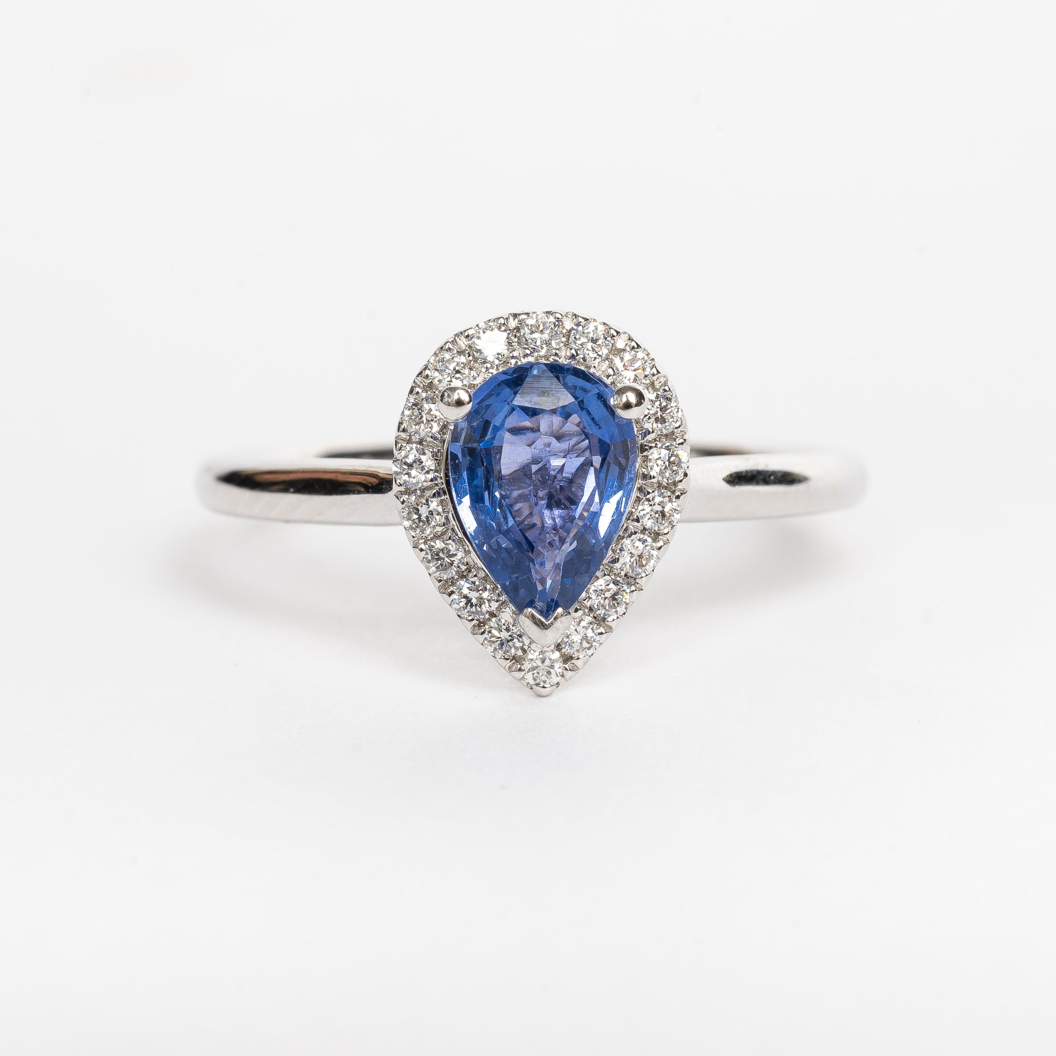 This white golden ring with a pear cut blue Sapphire is timeless. The blue Sapphire is surrounded by a halo of diamonds. The blue of the Sapphire and the white metal color match perfectly together.   The blue Sapphire gives your look a nice pop of color.   The pear cut is the most wanted fance shape.