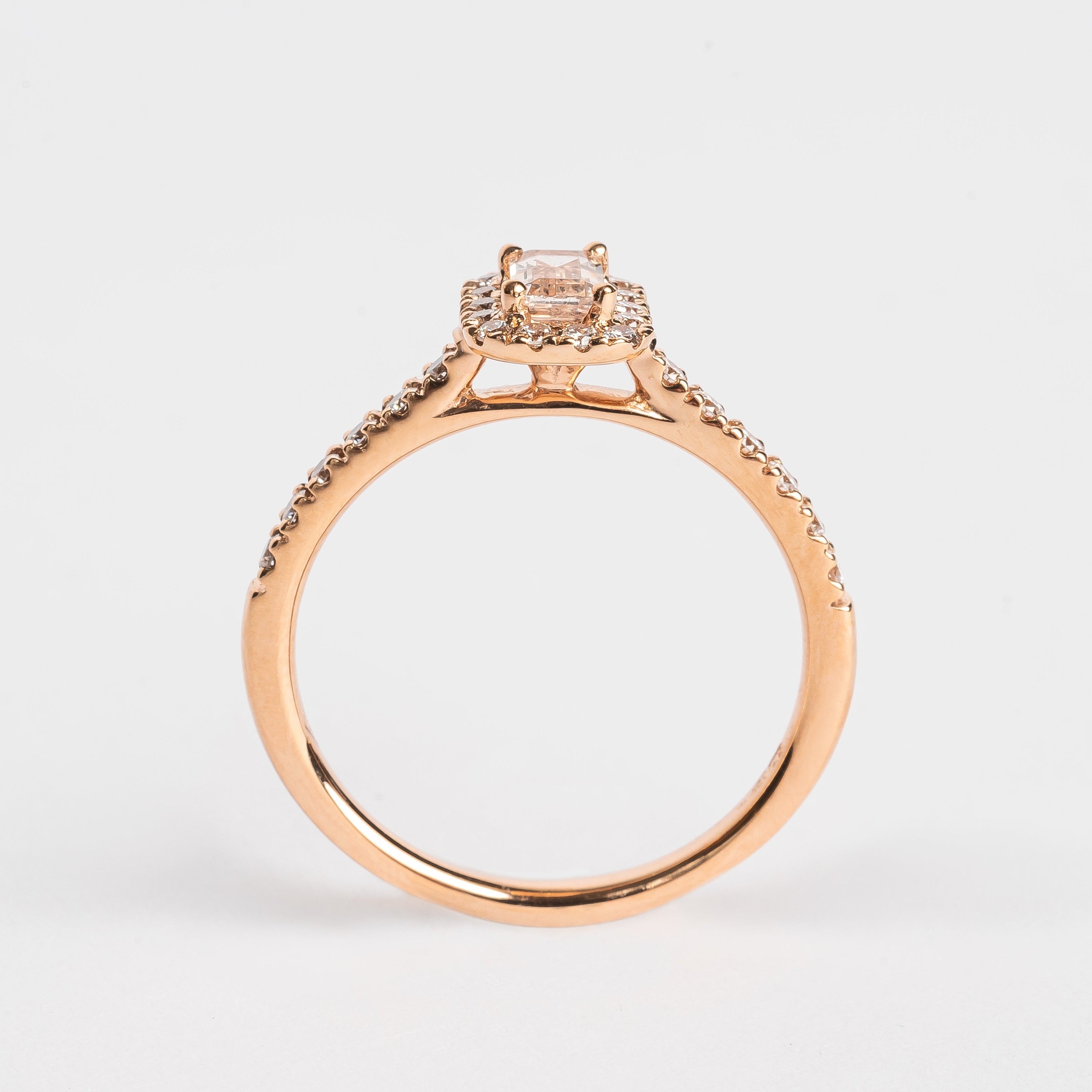 This gorgeous emerald cut Morganite ring made of rose gold is so pretty. The band is set with diamonds and the Marganite emerald cut is surround by a diamond halo. This fancy shape Morganite gemstone is pink. The rose gold and the pink Morganite are a true match.   18kt rose gold 