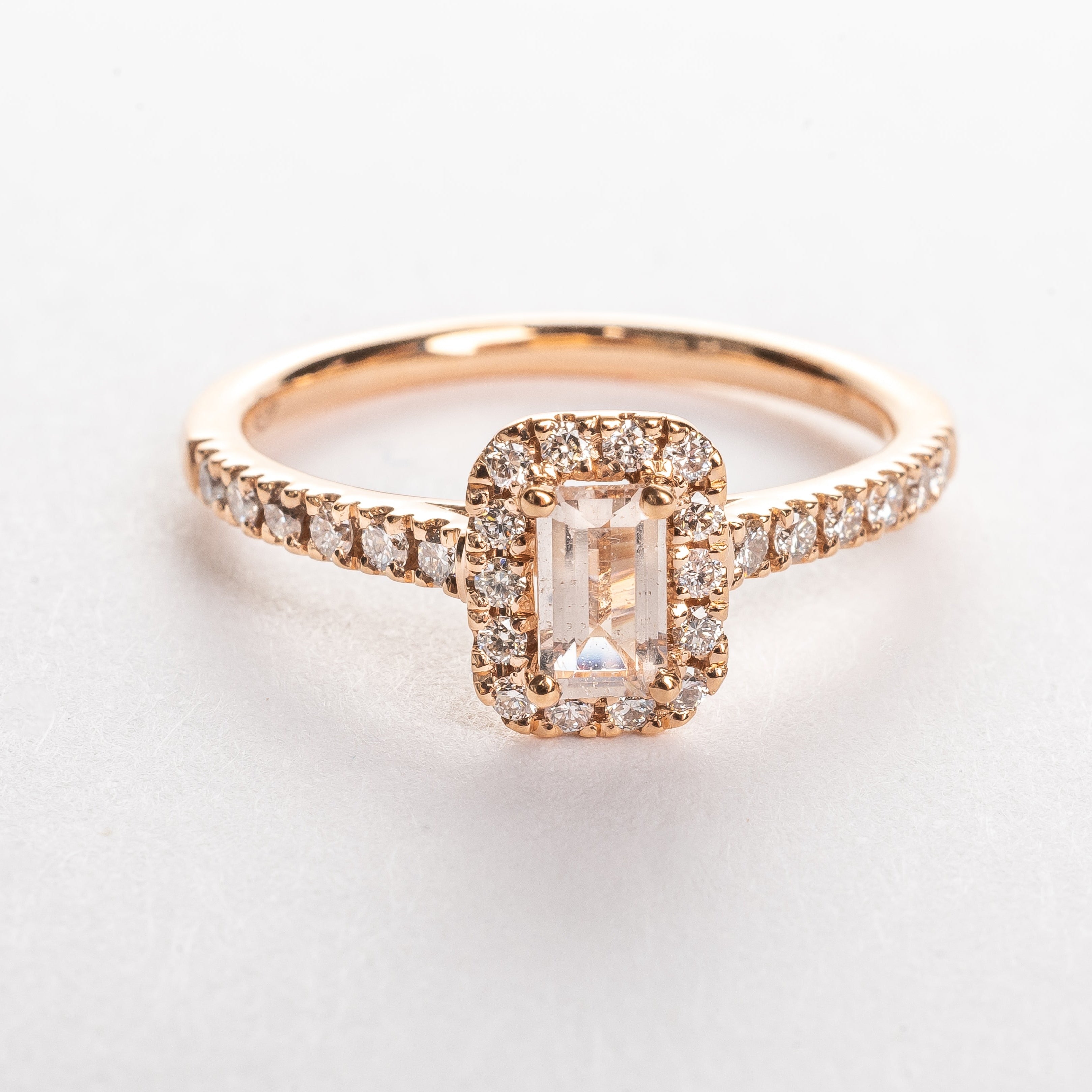 This gorgeous emerald cut Morganite ring made of rose gold is so pretty. The band is set with diamonds and the Marganite emerald cut is surround by a diamond halo. This fancy shape Morganite gemstone is pink. The rose gold and the pink Morganite are a true match.   18kt rose gold 