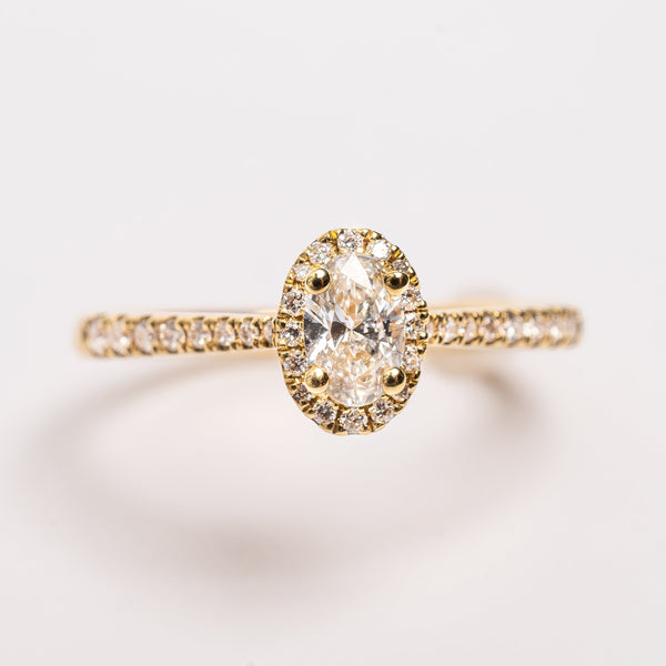 This ring with a oval cut diamond is special as the center stone is surrounded by a beautiful diamond halo.   The yellow gold comes true due to the perfect micro-claw setting of the stones. 