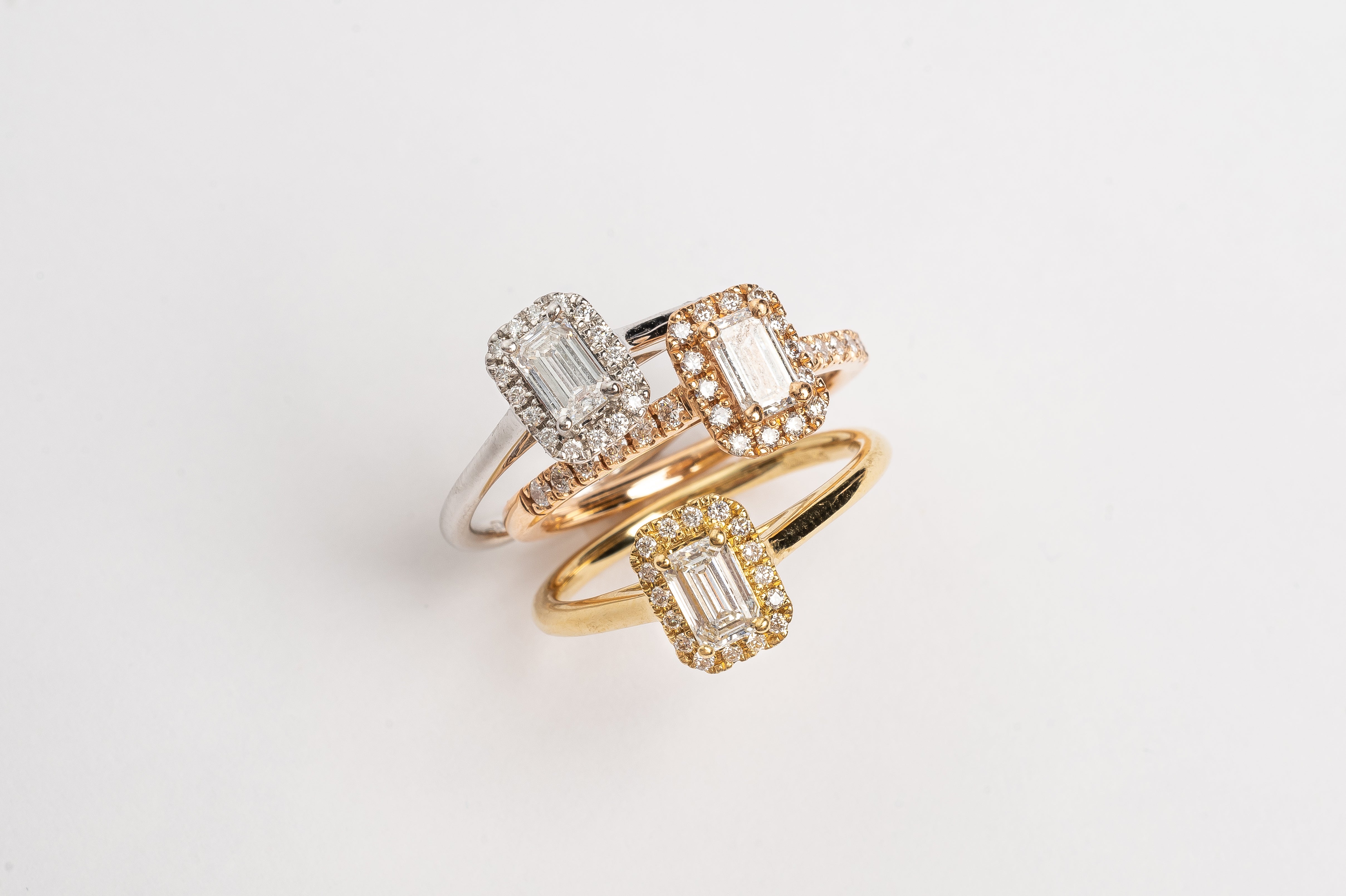 This gorgeous emerald cut Diamond ring made of white gold is beautiful. The band is plain and simple, this makes the diamond with the diamond halo stunning on your hand. This ring is made too fit a wedding band. 3 metal colors, white gold, yellow gold and rose gold.