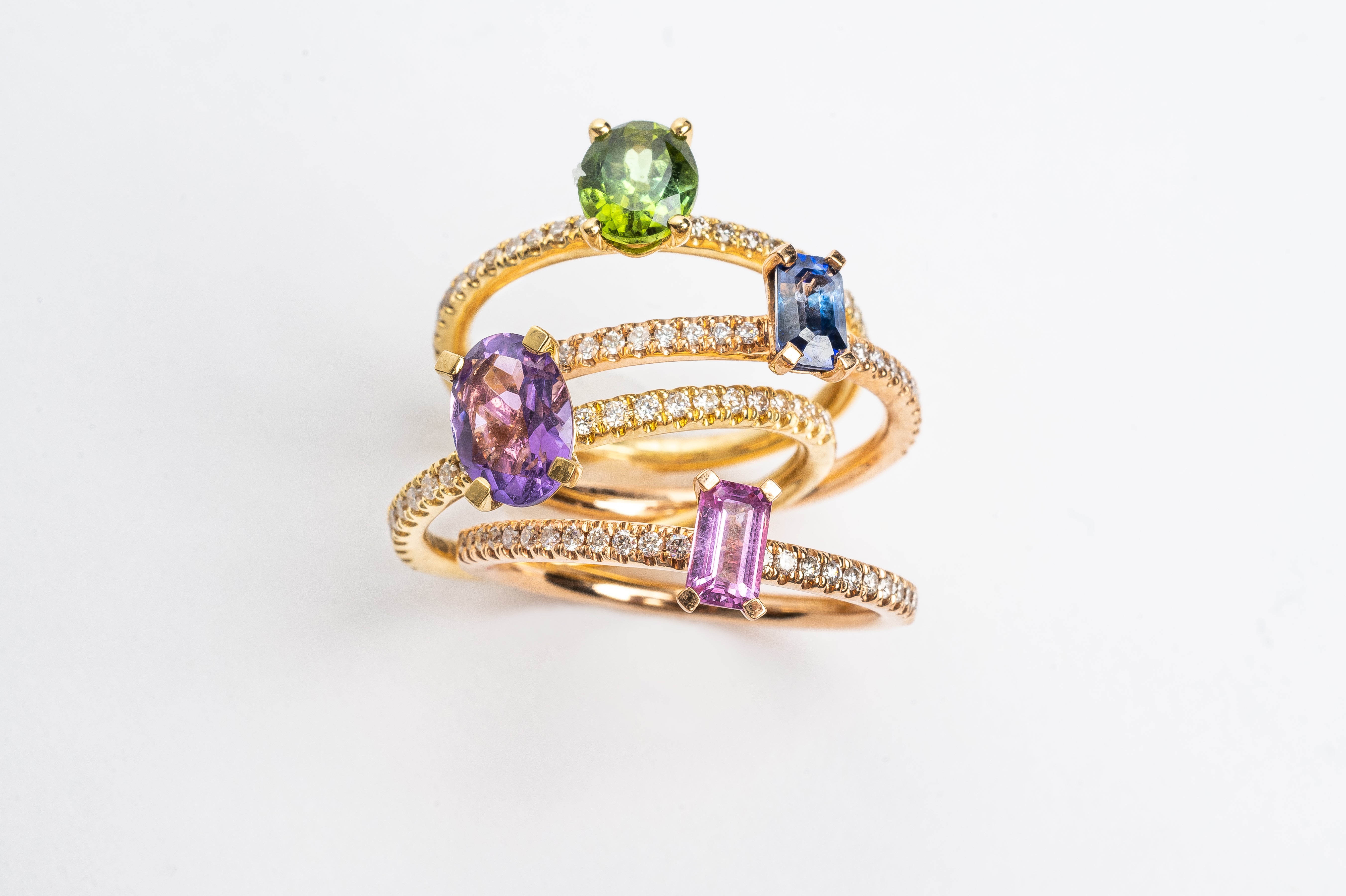 This pretty lilac oval cut Amethyst ring gives your look sparkle and color. It looks so nice and many will notice this pop of lilac on your hand. This lilac Amethyst matches very well with the yellow golden band.   18kt yellow gold. Comparison between blue Sapphire, green Peridot, Lilac Amethyst and Pink Tourmaline. 