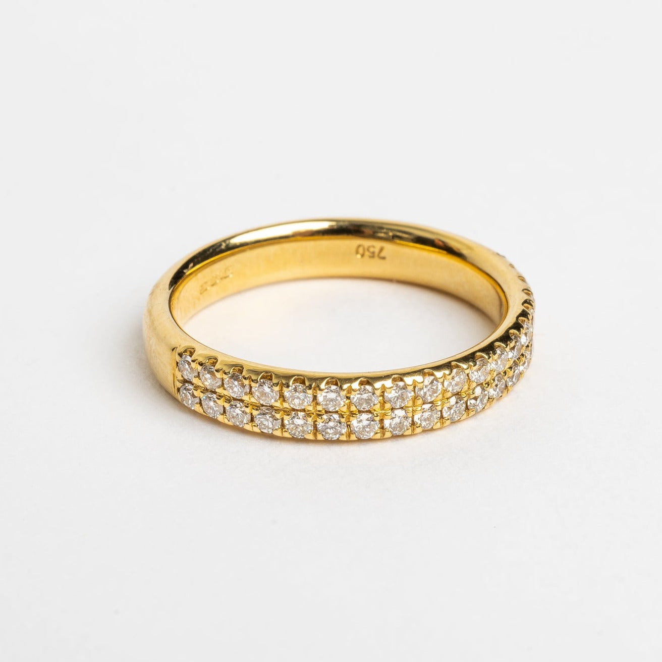 This double row designed ring in yellow gold is very pretty. De diamonds on this ring cover 50 % of the band. This ring is nice to wear by itself but also nice to stack with others.  18kt yellow gold Total diamond weight for the ring approx. 0.40ct round brilliant diamonds G-H/Si Band width 3.6 mm