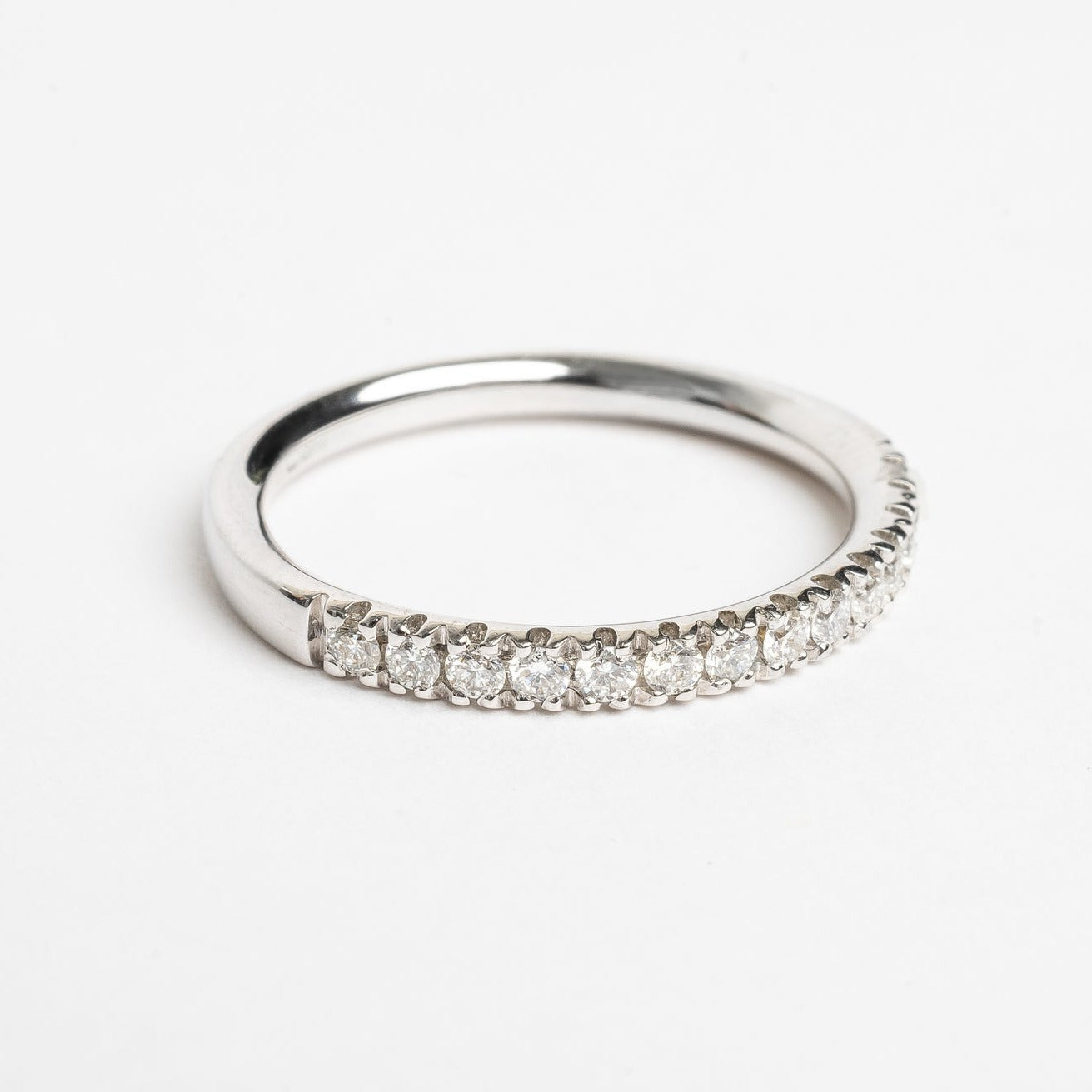 This beautiful eternity ring is 50 % set with diamonds. Every diamond is set with 4 claws, these diamonds are not going anywhere. The claws between every diamond and the diamonds itself make the ring sparkle from every side. It's a beautiful addition to your stack, can be worn as a wedding ring next to and engagement ring or alone on any finger.