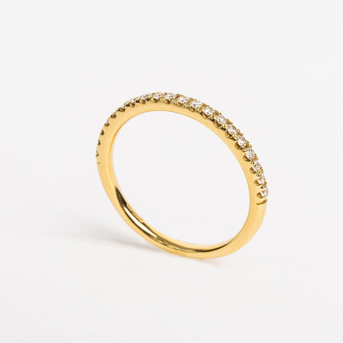 This beautiful yellow golden eternity ring is 50 % set with diamonds. Every diamond is set with 4 claws, these diamonds are not going anywhere. The claws between every diamond and the diamonds itself make the ring sparkle from every side. It's a beautiful addition to your stack, can be worn as a wedding ring next to and engagement ring or alone on any finger. 