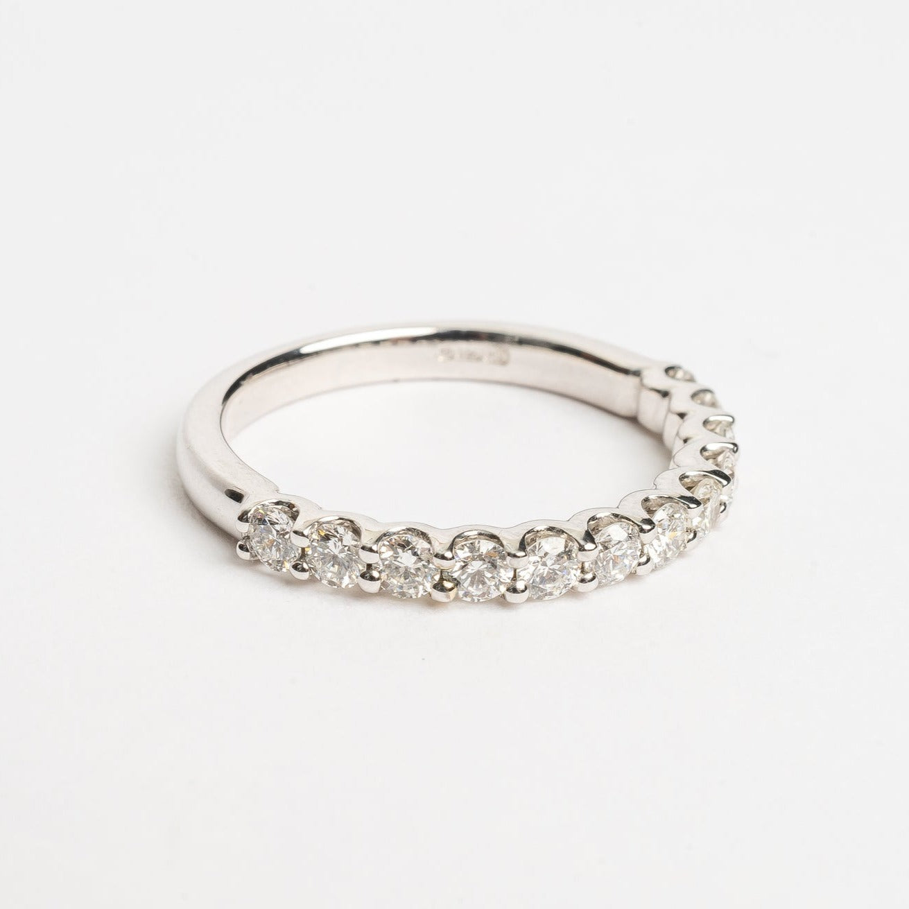 Eternity ring shared claw setting 2.5mm wide. This ring is perfect to celebrate any beautiful moment in life. This band is 50 % set with round brilliant diamonds and each diamond shares a claw setting with the next.   18kt white gold Total diamond weight for the ring approx. 0.35 round brilliant diamonds