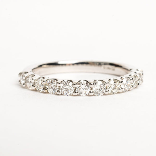 Eternity ring shared claw setting 2.5mm wide. This ring is perfect to celebrate any beautiful moment in life. This band is 50 % set with round brilliant diamonds and each diamond shares a claw setting with the next.   18kt white gold Total diamond weight for the ring approx. 0.35 round brilliant diamonds