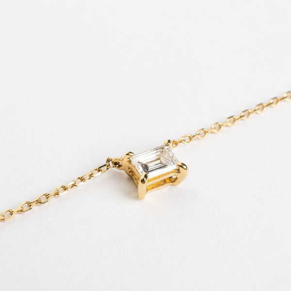 This mini baguette necklace is so refined and elegant. This necklace gives your neck a subtle touch of sparkle. This necklace is elegant by itself, but also very nice to layer with other necklaces.   18kt yellow gold 4.4 mm x 3.3 mm Baguette stone set with four claws Total diamond weight for the baguette is approx. 0.20ct Necklace length 40cm. Zoom