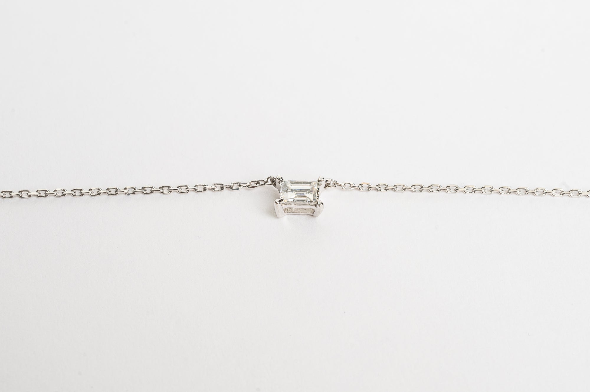 This mini baguette necklace is so refined and elegant. This necklace gives your neck a subtle touch of sparkle. This necklace is elegant by itself, but also very nice to layer with other necklaces.   18kt white gold 4.4 mm x 3.3 mm Baguette stone set with four claws Total diamond weight for the baguette is approx. 0.20ct Necklace length 40cm