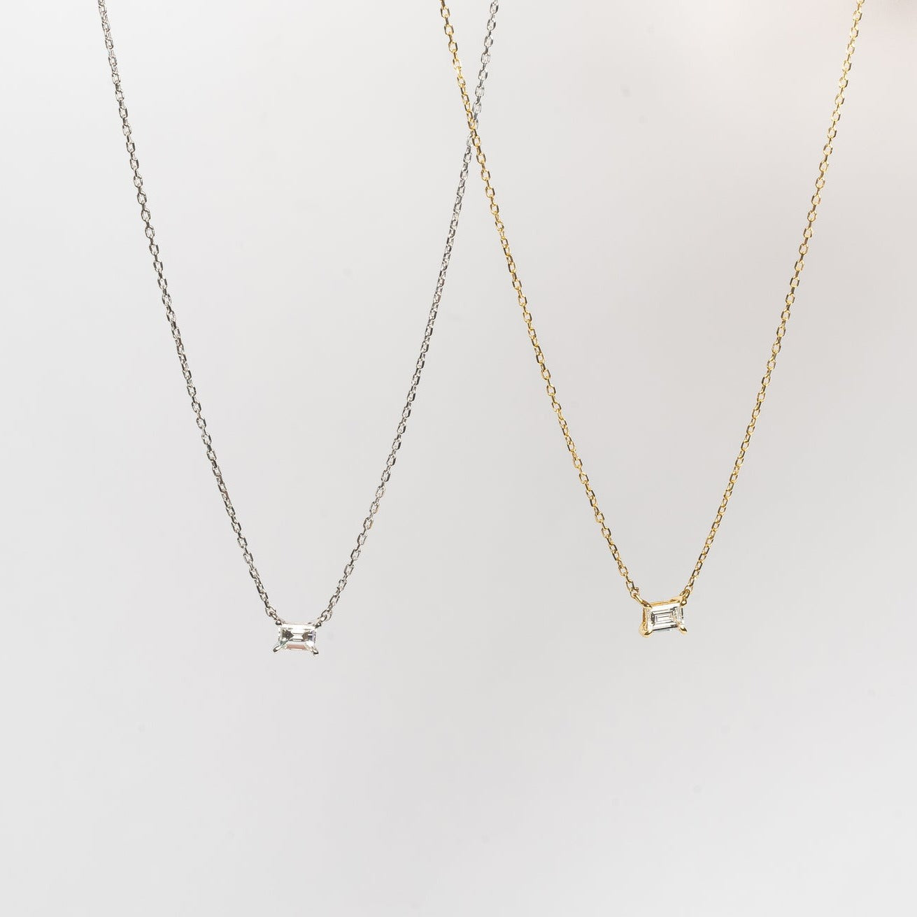 This mini baguette necklace is so refined and elegant. This necklace gives your neck a subtle touch of sparkle. This necklace is elegant by itself, but also very nice to layer with other necklaces.   18kt yellow gold 4.4 mm x 3.3 mm Baguette stone set with four claws Total diamond weight for the baguette is approx. 0.20ct Necklace length 40cm