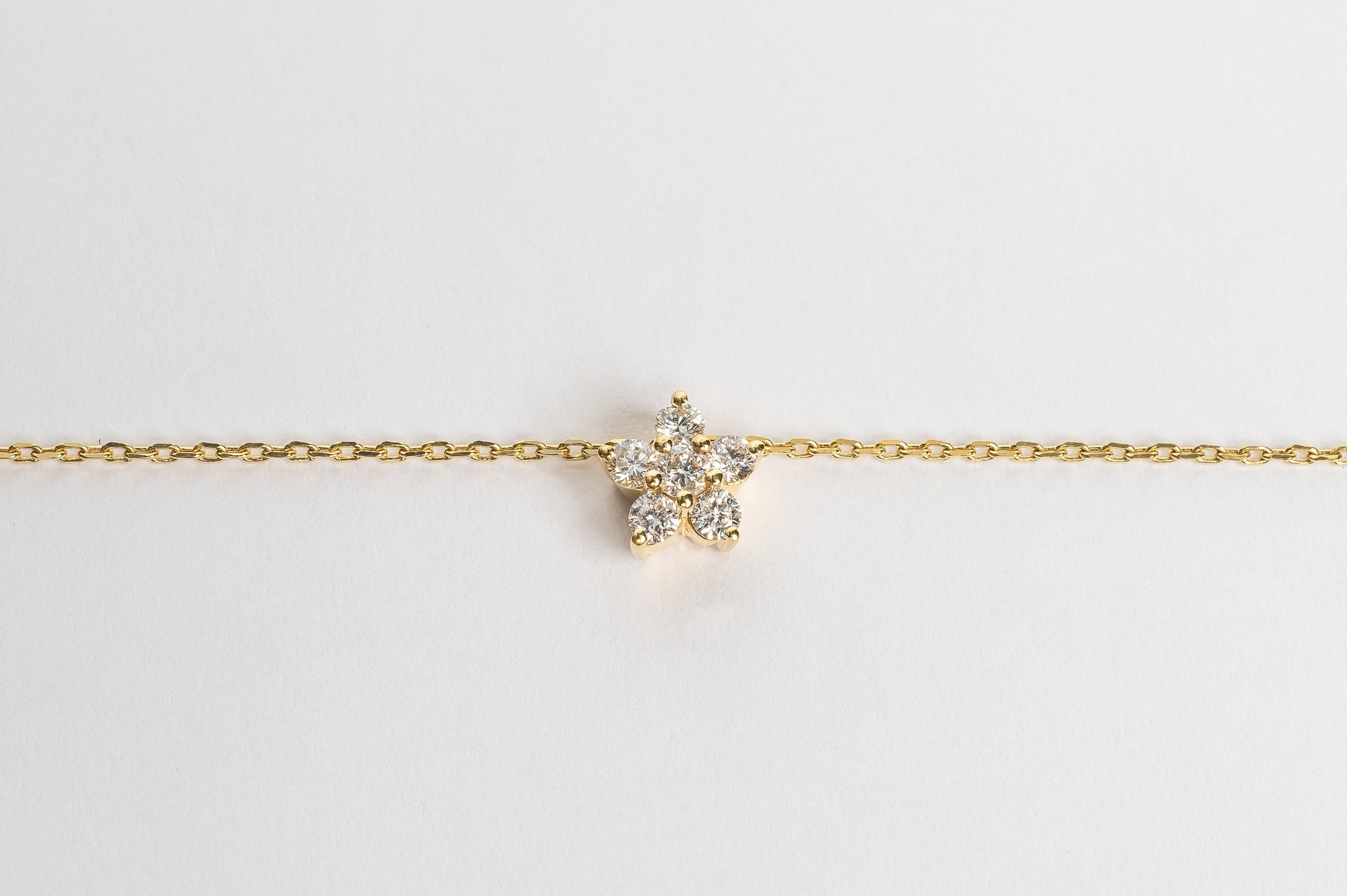 This elegant finished golden flower necklace is a classic piece to cherish forever. Elegant in its simplicity but refined in its design. The five leaves and the center stone make a beautiful design. 