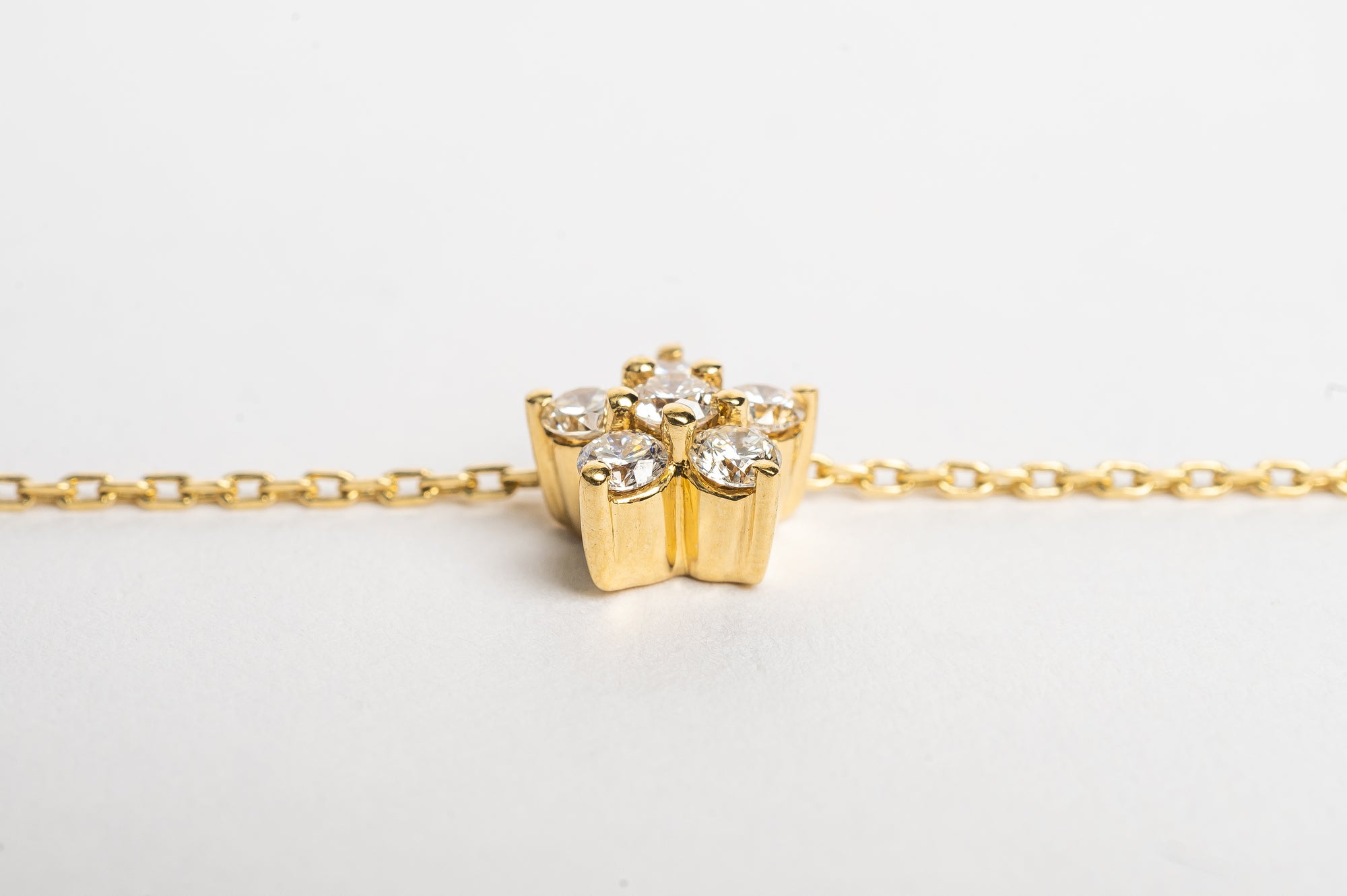 This elegant finished golden flower necklace is a classic piece to cherish forever. Elegant in its simplicity but refined in its design. The five leaves and the center stone make a beautiful design. 