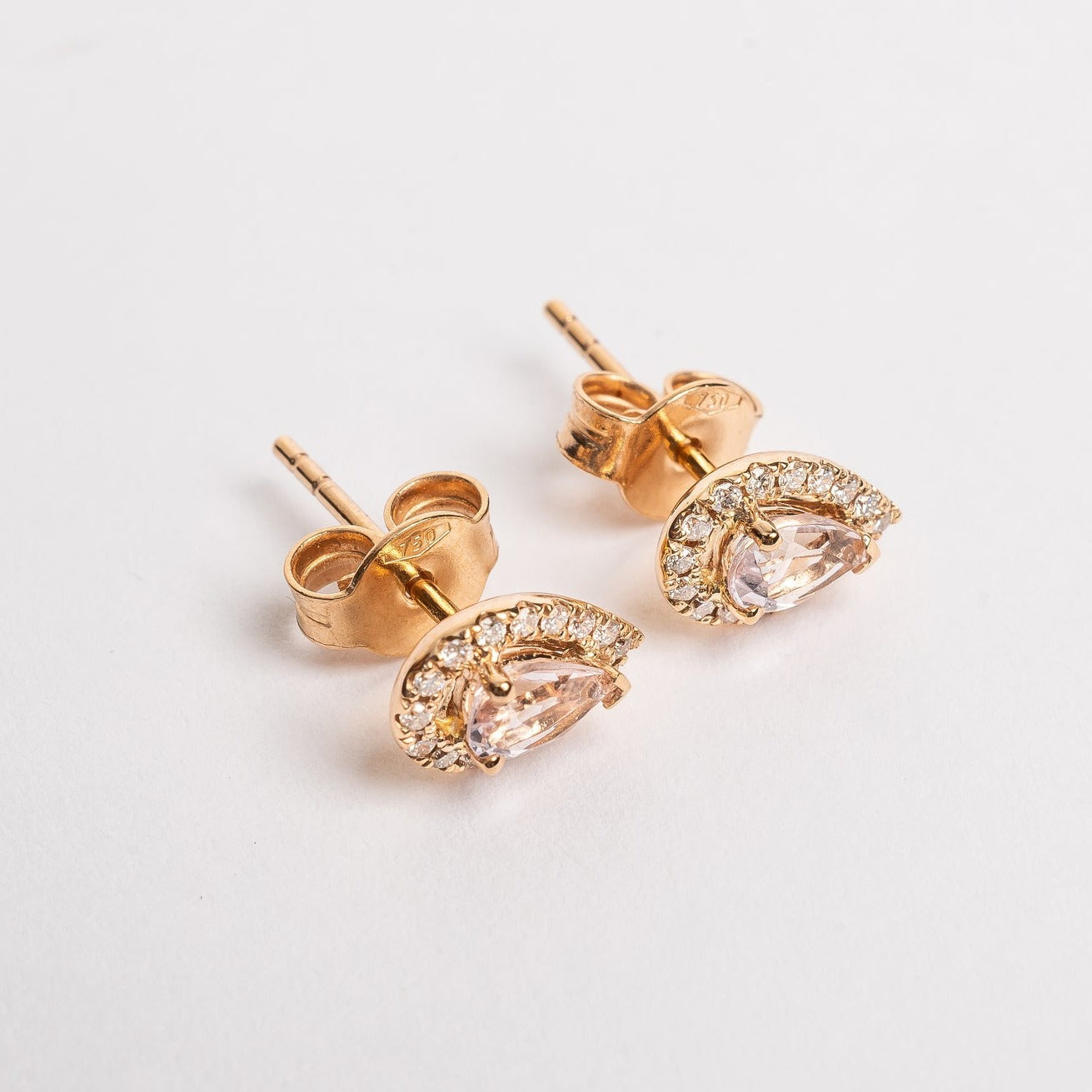 A pear is the most sold fancy shape on the market, they are hot. These Pear peach Morganite and diamonds halo studs are pretty and fit on all ears.   18kt rose gold