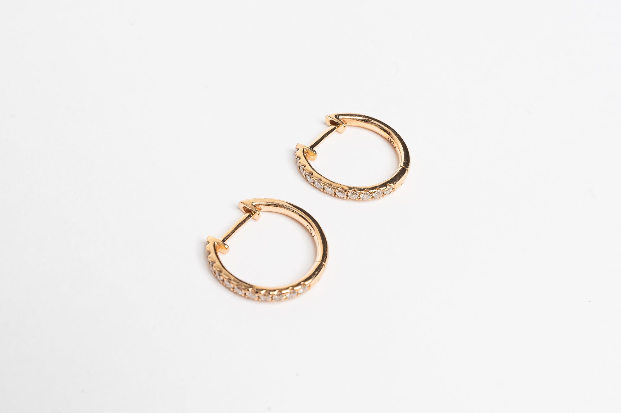 These claw set diamond hoops. A timeless setting on a modern style earrings. You will love to wear these earrings everyday.  You can wear them alone or you can stack them together with other piercings for a full look. 