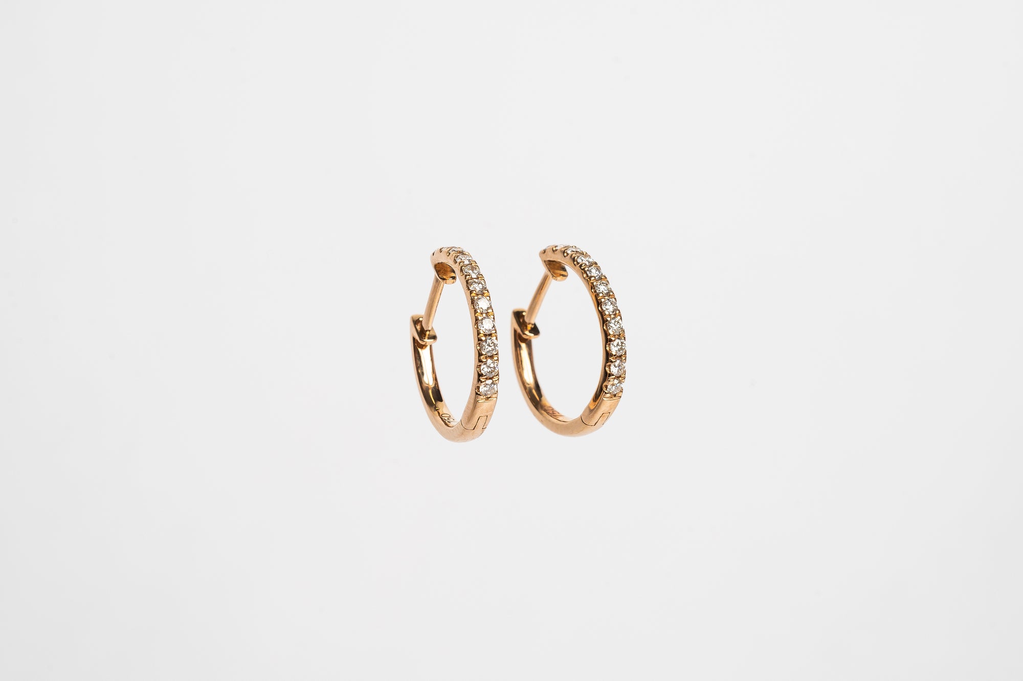 These claw set diamond hoops. A timeless setting on a modern style earrings. You will love to wear these earrings everyday.  You can wear them alone or you can stack them together with other piercings for a full look. 