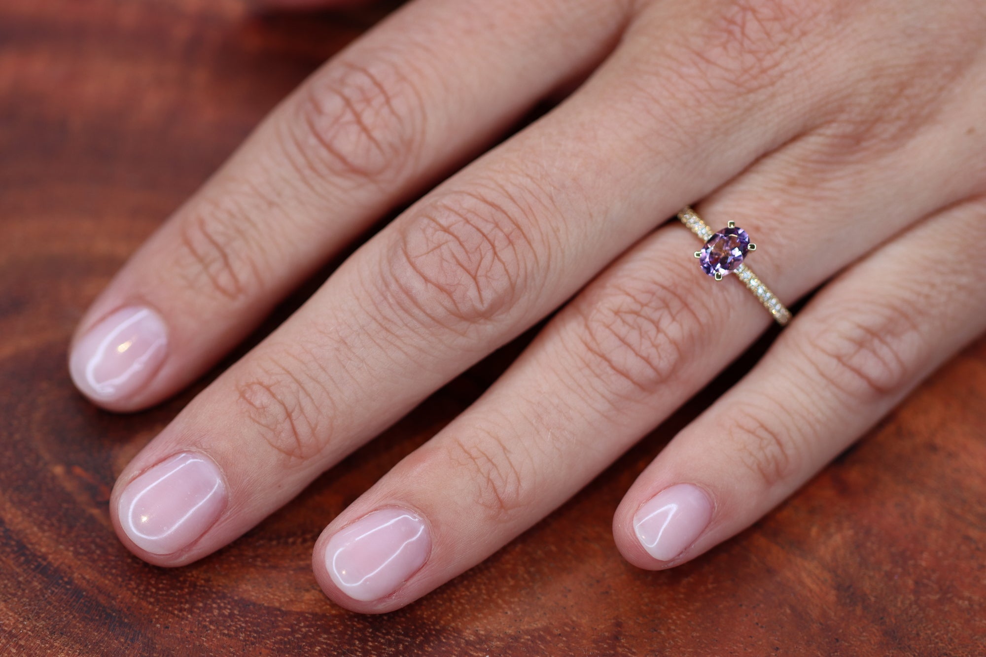 This pretty lilac oval cut Amethyst ring gives your look sparkle and color. It looks so nice and many will notice this pop of lilac on your hand. This lilac Amethyst matches very well with the yellow golden band.   18kt yellow gold