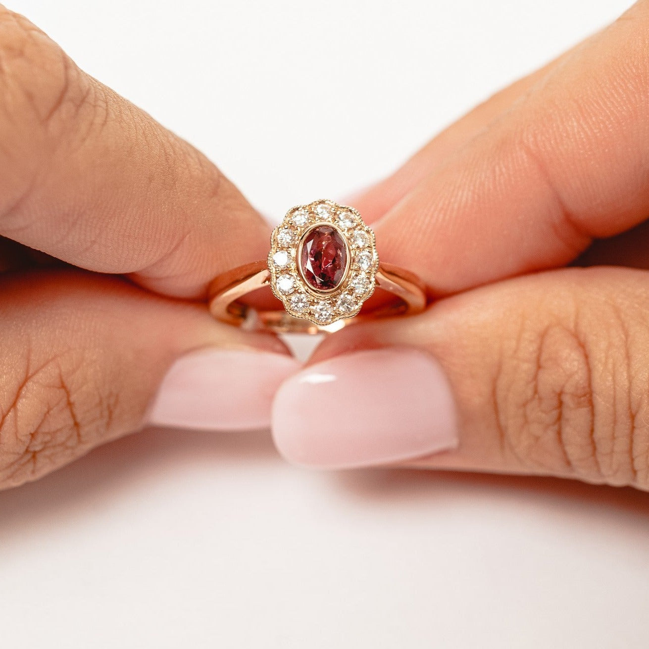 This elegant ring is set with beautiful natural diamonds and with an oval cut red garnet. The ring is made from 18kt rose gold.   From this gorgeous style we have created a matching necklace and earrings. You can find them in our webshop too when you filter on red garnet or colored gemstone styles.   18kt rose gold