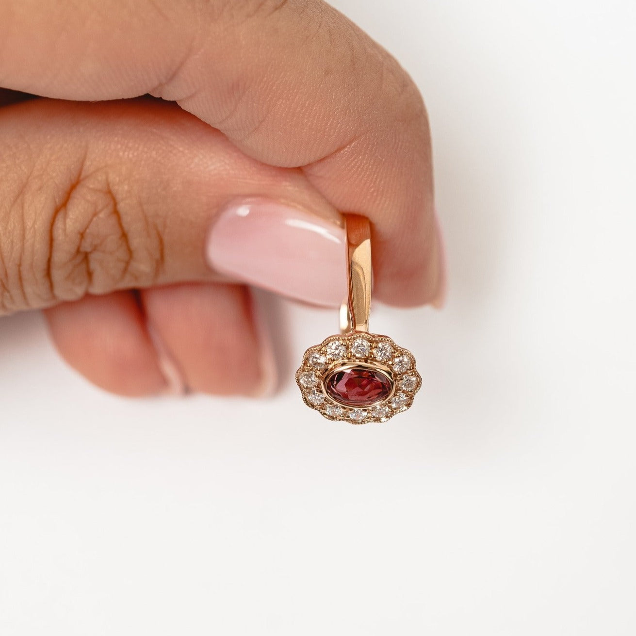 This elegant ring is set with beautiful natural diamonds and with an oval cut red garnet. The ring is made from 18kt rose gold.   From this gorgeous style we have created a matching necklace and earrings. You can find them in our webshop too when you filter on red garnet or colored gemstone styles. 