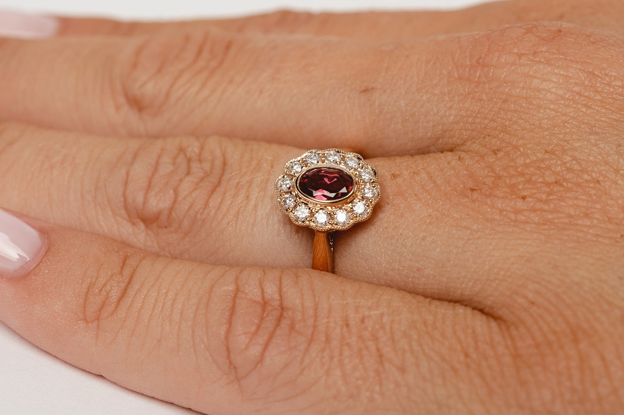 This elegant ring is set with beautiful natural diamonds and with an oval cut red garnet. The ring is made from 18kt rose gold.   From this gorgeous style we have created a matching necklace and earrings. You can find them in our webshop too when you filter on red garnet or colored gemstone styles. 