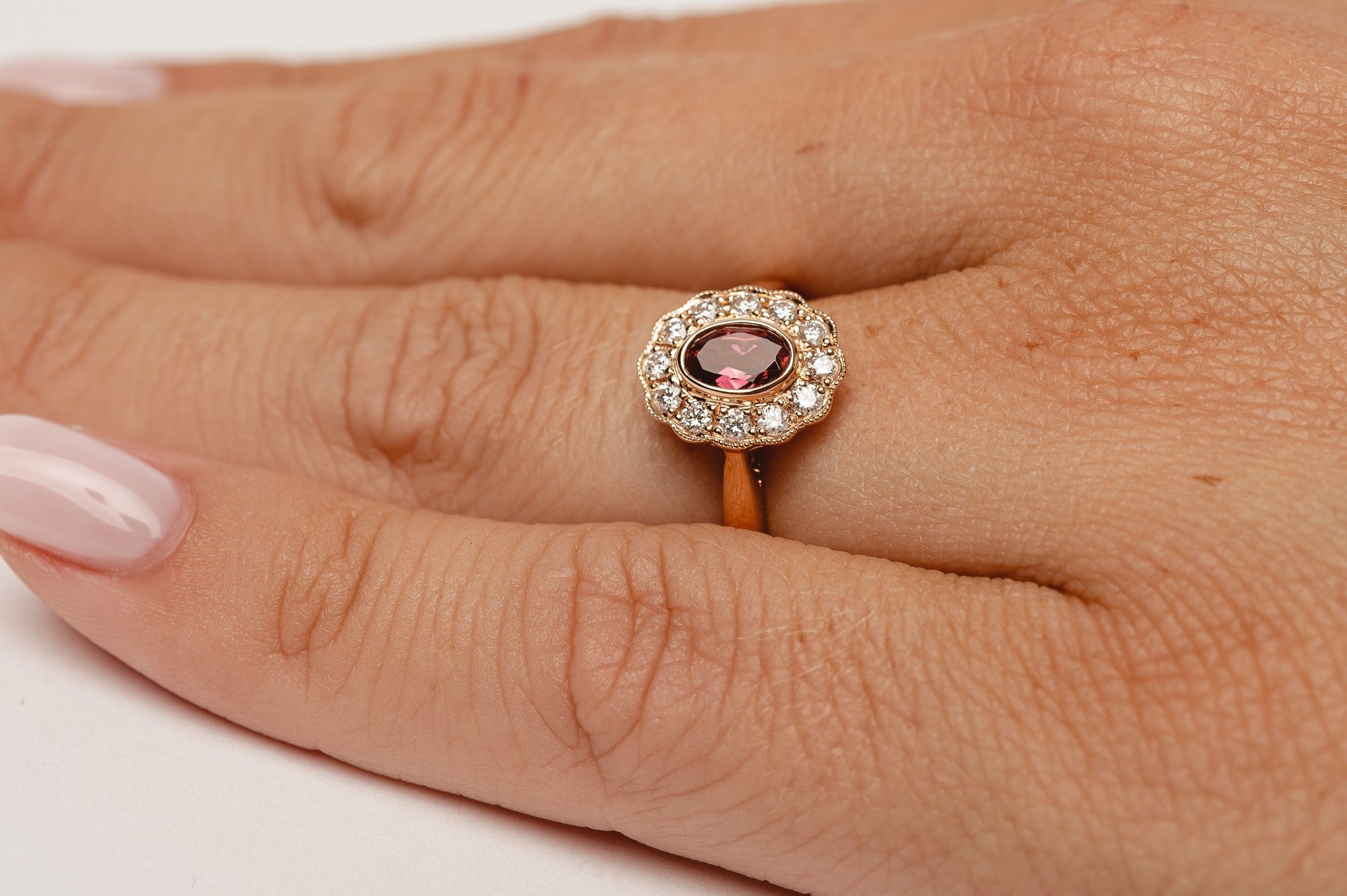 This elegant ring is set with beautiful natural diamonds and with an oval cut red garnet. The ring is made from 18kt rose gold.   From this gorgeous style we have created a matching necklace and earrings. You can find them in our webshop too when you filter on red garnet or colored gemstone styles. 