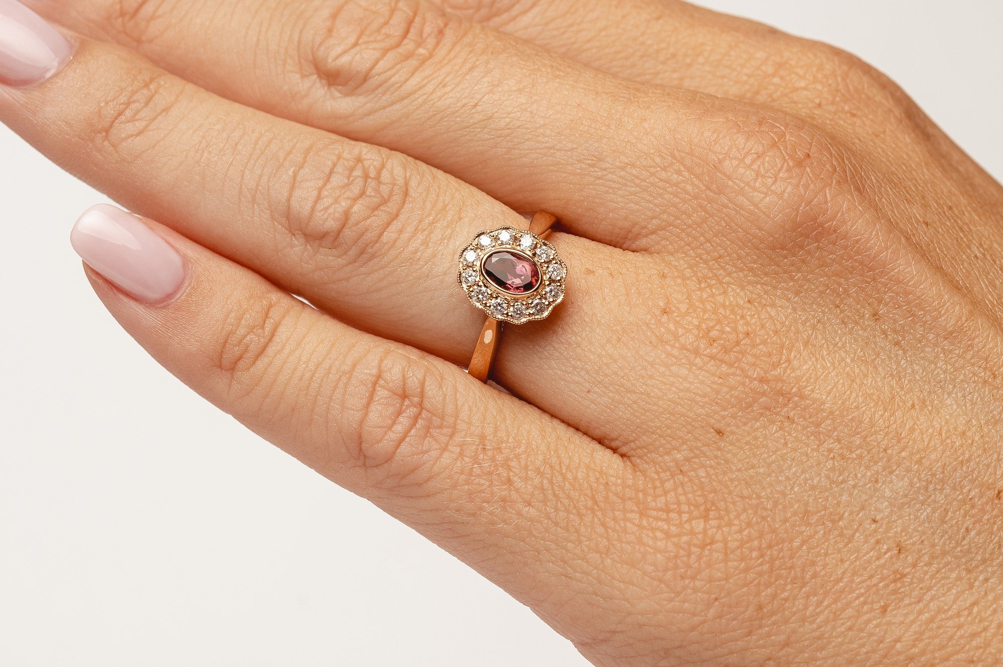 This elegant ring is set with beautiful natural diamonds and with an oval cut red garnet. The ring is made from 18kt rose gold.   From this gorgeous style we have created a matching necklace and earrings. You can find them in our webshop too when you filter on red garnet or colored gemstone styles. 