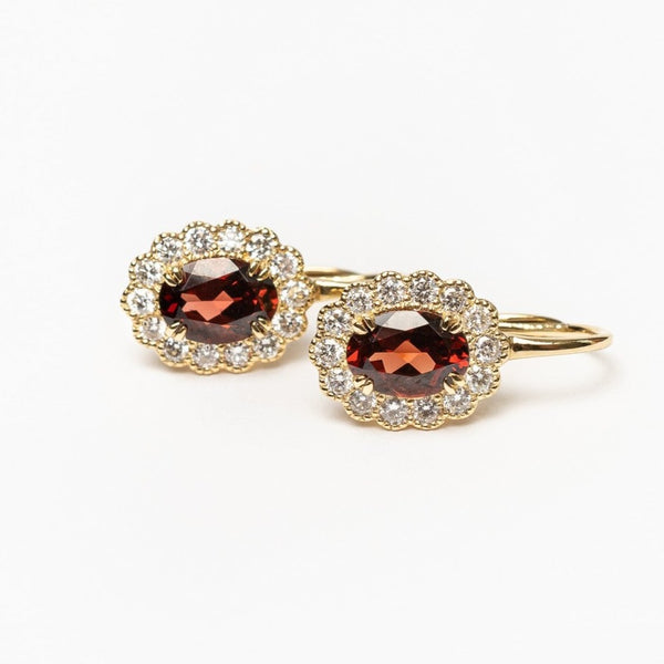 Oval cut red garnet vintage earrings This elegant earrings are set with beautiful natural diamonds and with an oval cut red garnet. These earrings are made with 18kt rose gold.  From this gorgeous style we have created a matching ring and necklace. You can find them in our webshop when you filter on red garnet or colored gemstone styles. 