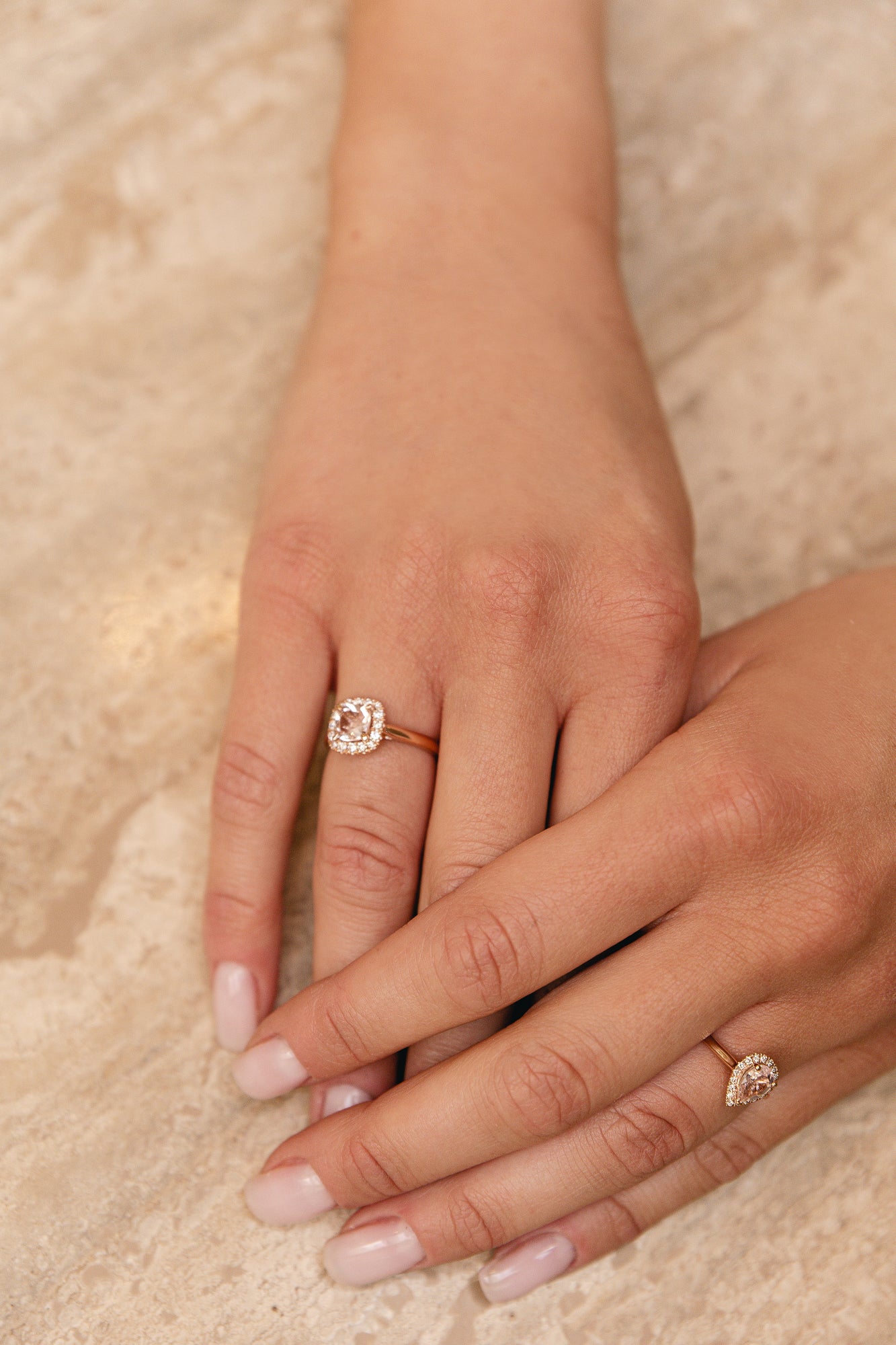 What a beautiful ring! The Morganite is cut in a cushion shape and surrounded by diamond halo of round brilliant diamonds. The soft peachy pink color of the stone matches so beautifully with the rose metal color of the ring.   18kt rose gold