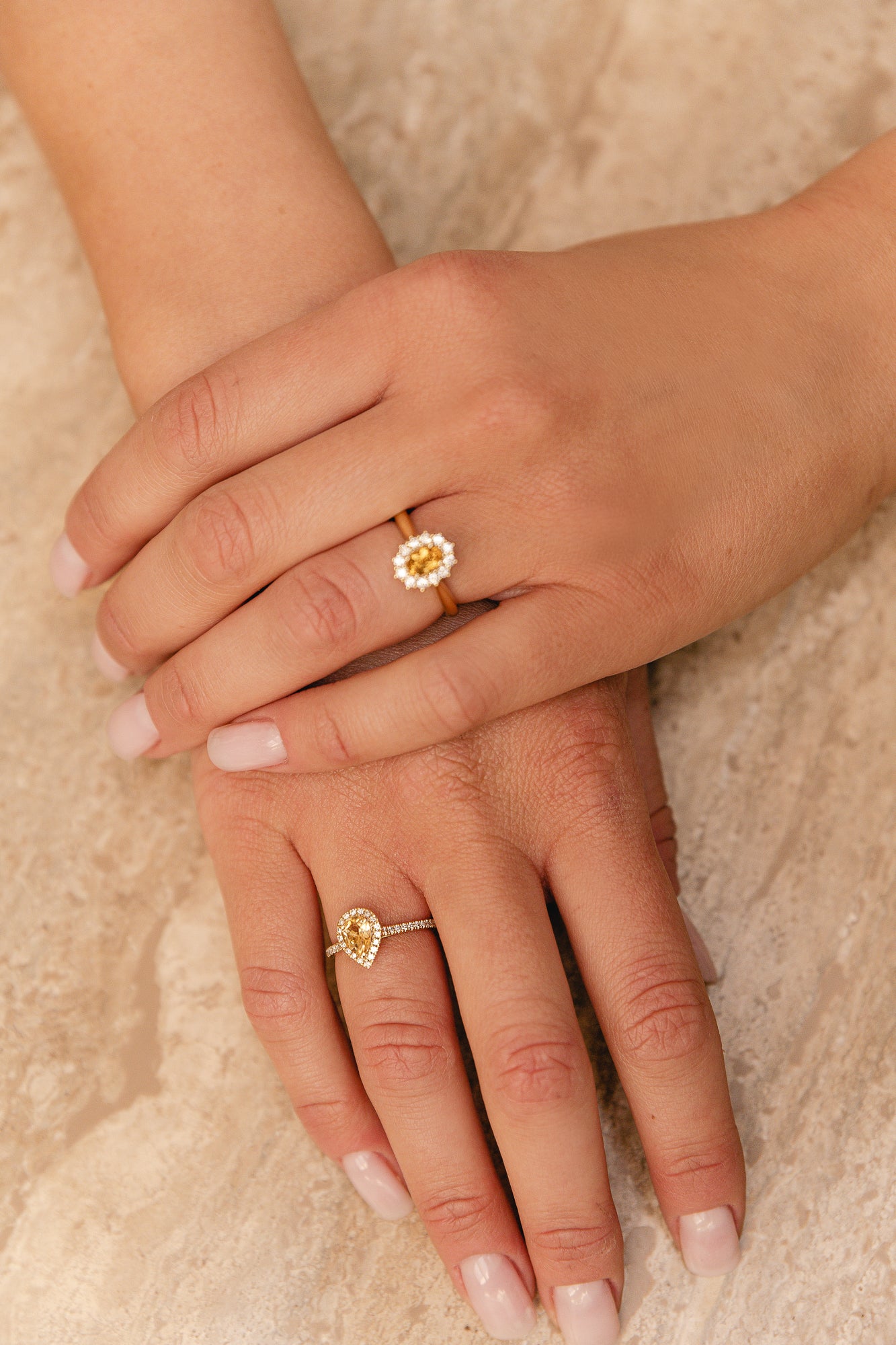 This yellow golden ring is set with round diamonds on the side, and a pear cut Citrine gemstone in the center, surrounded by a pear shaped halo.  This ring is so beautiful on its own and needs no stacked rings on the side.   This gemstone is believed to have healing powers. It has a warm yellow hue. Citrine is one of the most popular gemstones in the quartz family. 